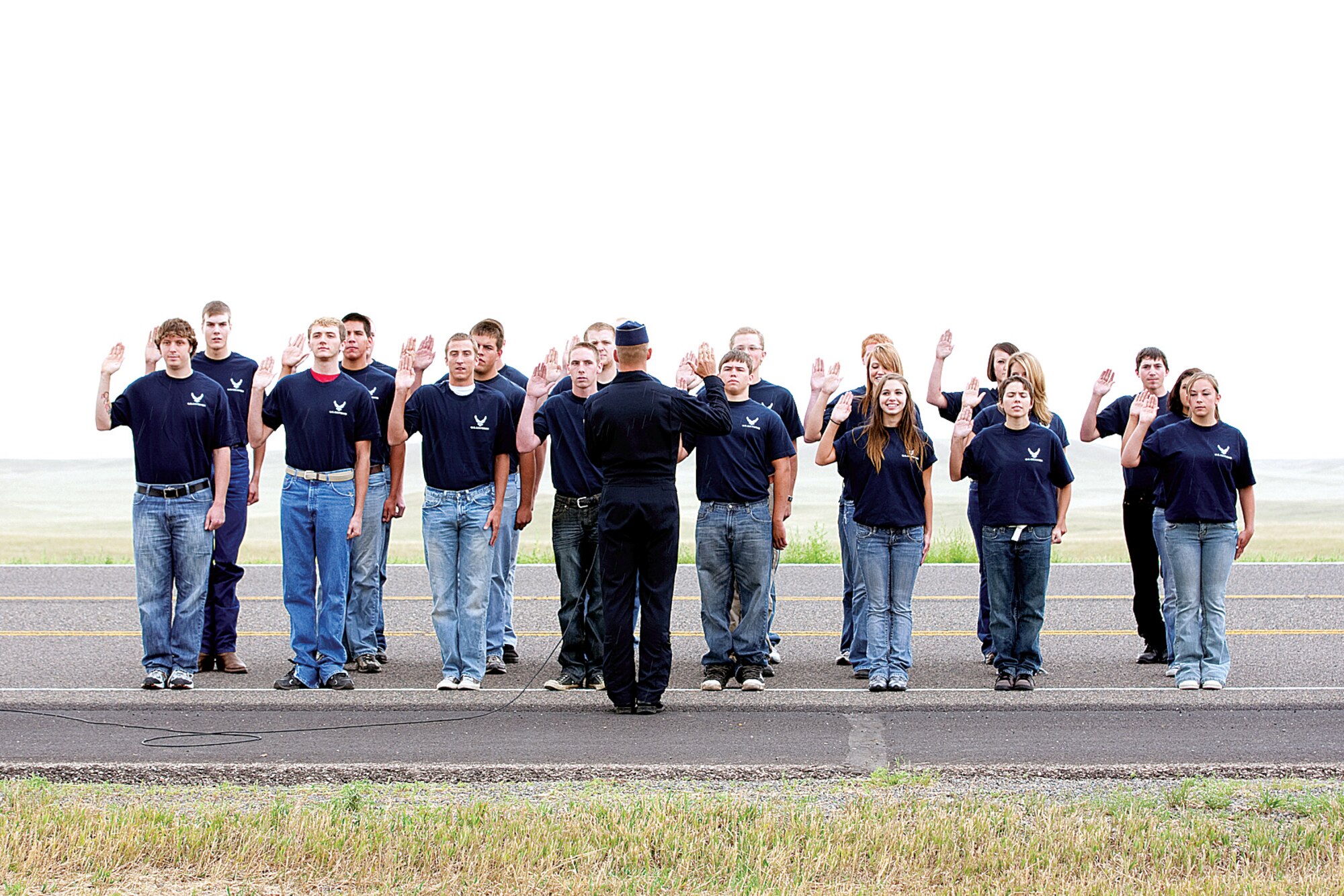 Lt. Col. Derek Routt, Thunderbird 7, operations officer, swears in 23 civilians into the Delayed Enlistment Program on July 28. The DEP participants are Brian Abbott, Brandon Burgess, Zachary Chambers, Ashley Connely, Michael Dejean, Robert Eby, Owen Erickson, Obie Halle, Andrew Hauber, Kaitlin Ilgen, Kassy Kadrmas, Tylor King, Christopher Kowalke, Ryan Lewallen, Lukas Ludwig, Kaytlyn Mapes, Alystria Maurer, Matthew Randolph, James Strutz, Dock Stuart, Megan Thorlund, Desiree Valenciano and Mellisa Williams. (U.S. Air Force photo by Jeff Allred)