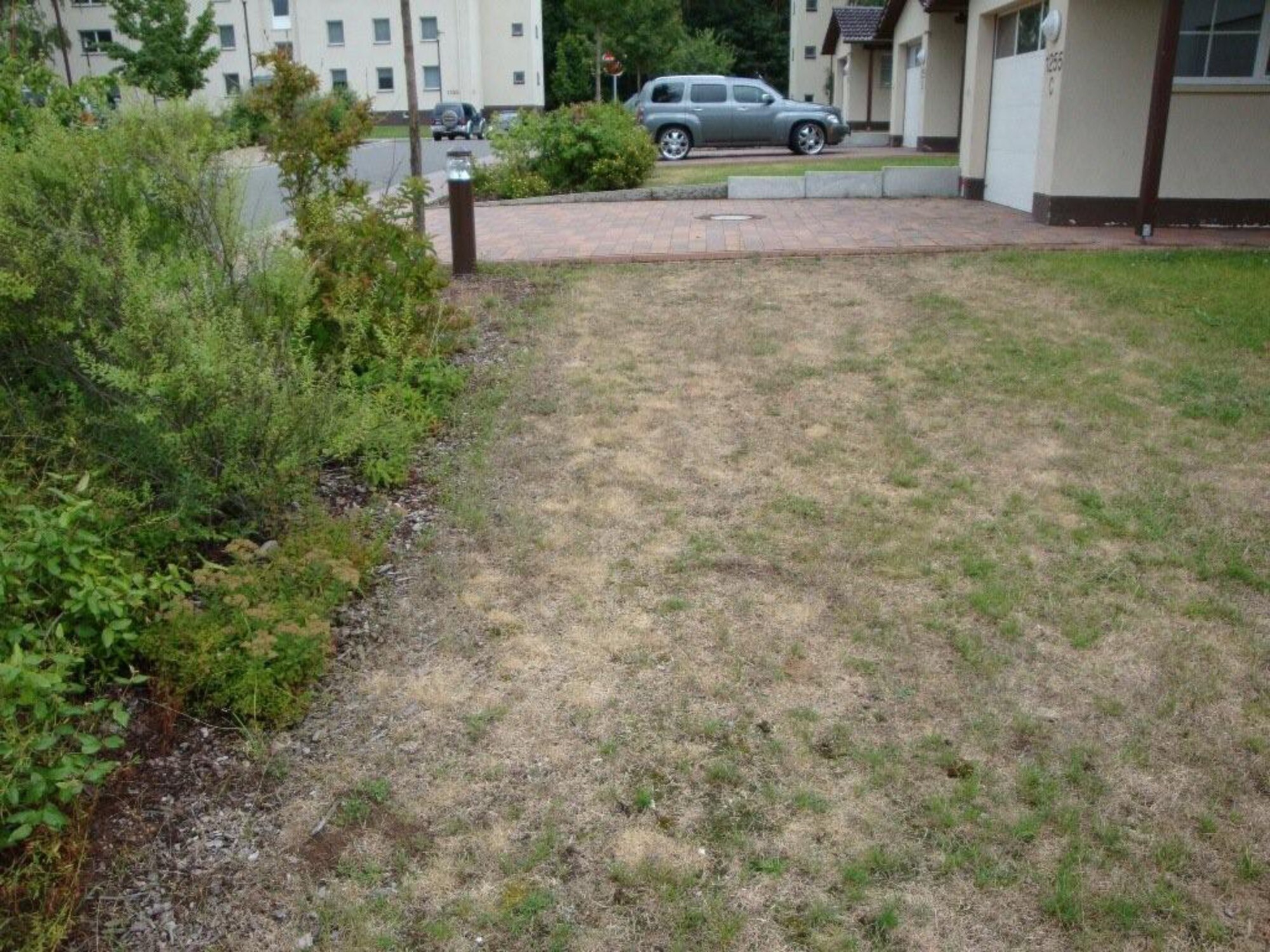Dead grass stands waiting water in the yard of a base house in the Kaiserslautern Military Community housing area. Recently, during weekly exterior inspections, it has been noticed that some residents are not keeping their homes and yards up to standard. One such area where residents are not adhearing to the rules is exterior appearance. (Courtesy photo)