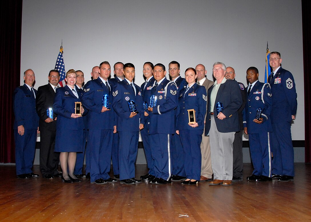 Col. Michael Hake (left) and Chief Master Sgt. David Nelson (right), stand with the awardees at the 82nd Training Wing Quarterly Awards ceremony at the base theater on Sheppard Air Force Base, Texas, July 30. The 82nd TRW Vice Commander and Command Chief awarded the winners with plaques in one of 20 different categories. (U.S. Air Force photo/Michael Litteken)
