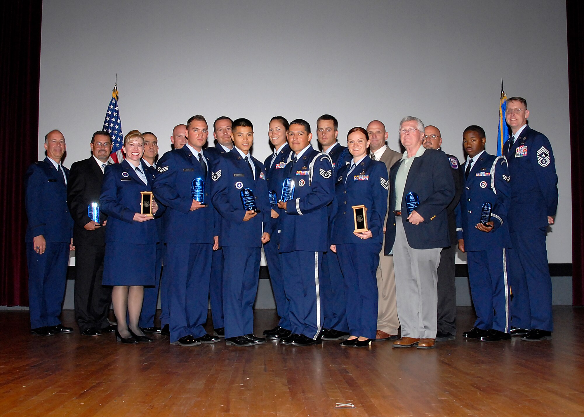 Col. Michael Hake (left) and Chief Master Sgt. David Nelson (right), stand with the awardees at the 82nd Training Wing Quarterly Awards ceremony at the base theater on Sheppard Air Force Base, Texas, July 30. The 82nd TRW Vice Commander and Command Chief awarded the winners with plaques in one of 20 different categories. (U.S. Air Force photo/Michael Litteken)