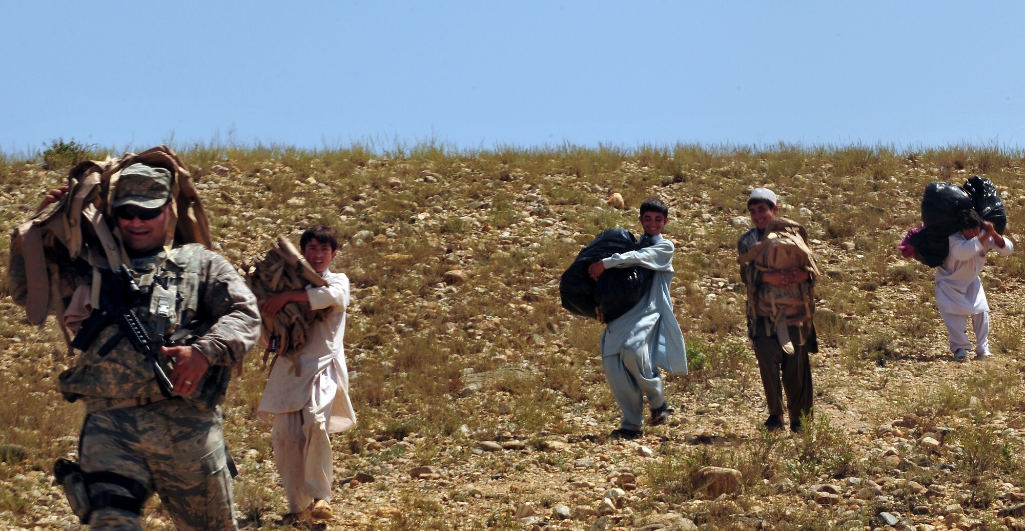 100809-N-6031Q-009 KABUL, Afghanistan - Airmen from the Afghan Air Force 201st Corps, the U.S. Air Force 438th Air Expeditionary Wing and the 438th Air Expeditionary Advisory Wing prepared and delivered humanitarian aid consisting of school supplies for 600 students, sporting equipment, bedding, a large tent, and an all weather Afghanistan flag to the Chinari village in the outskirts of Kabul, Afghanistan on Aug. 9, 2010. (US Navy photo by Mass Communication Specialist 2nd Class David Quillen/ RELEASED).