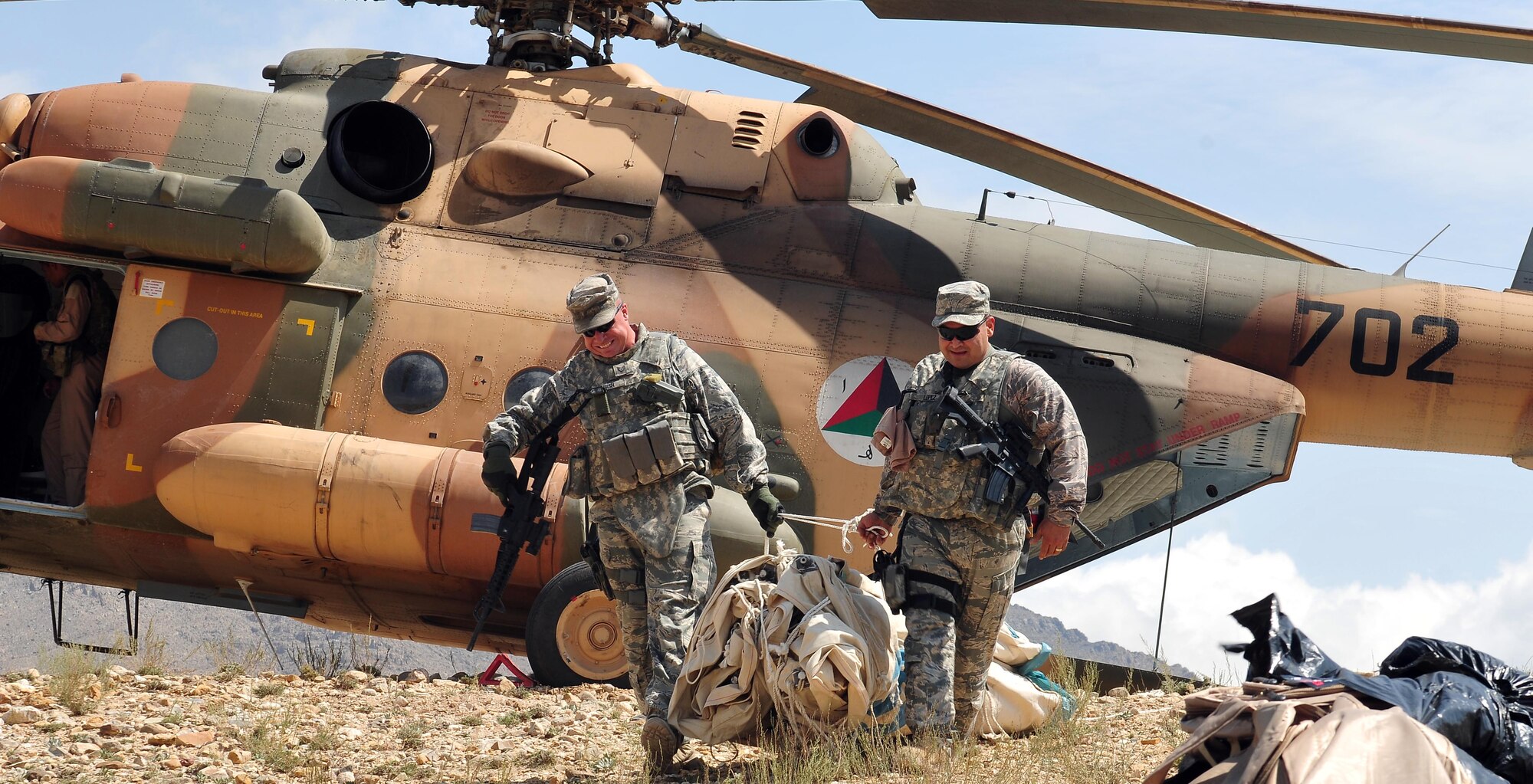 100809-N-6031Q-007 KABUL, Afghanistan - Airmen from the Afghan Air Force 201st Corps, the U.S. Air Force 438th Air Expeditionary Wing and the 438th Air Expeditionary Advisory Wing prepared and delivered humanitarian aid consisting of school supplies for 600 students, sporting equipment, bedding, a large tent, and an all weather Afghanistan flag to the Chinari village in the outskirts of Kabul, Afghanistan on Aug. 9, 2010. (US Navy photo by Mass Communication Specialist 2nd Class David Quillen/ RELEASED).
