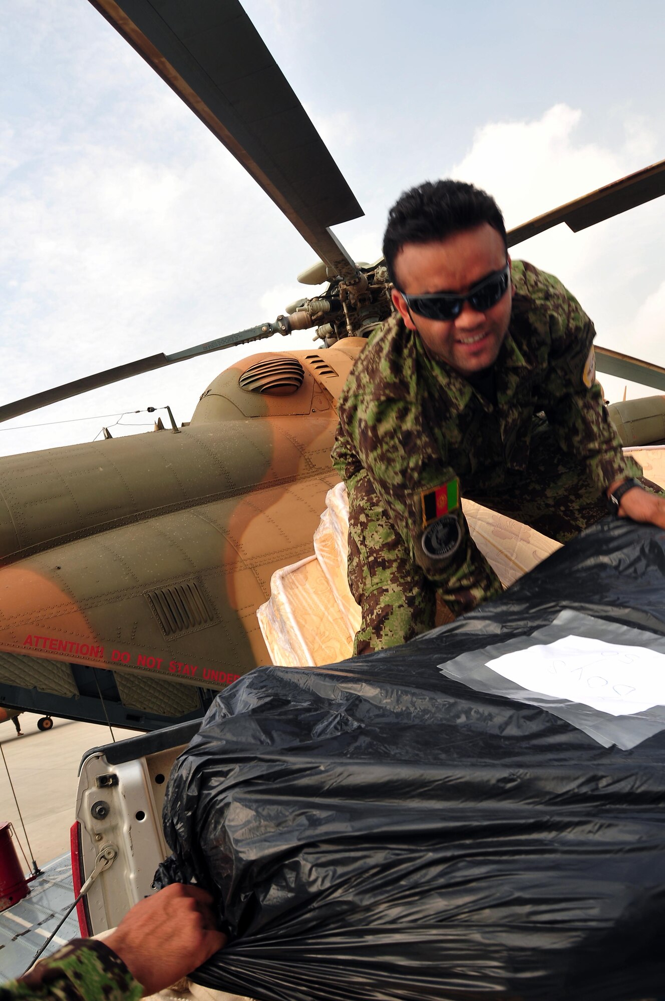 100809-N-6031Q-002 KABUL, Afghanistan - Airmen from the Afghan Air Force 201st Corps, the U.S. Air Force 438th Air Expeditionary Wing and the 438th Air Expeditionary Advisory Wing prepared and delivered humanitarian aid consisting of school supplies for 600 students, sporting equipment, bedding, a large tent, and an all weather Afghanistan flag to the Chinari village in the outskirts of Kabul, Afghanistan on Aug. 9, 2010. (US Navy photo by Mass Communication Specialist 2nd Class David Quillen/ RELEASED).