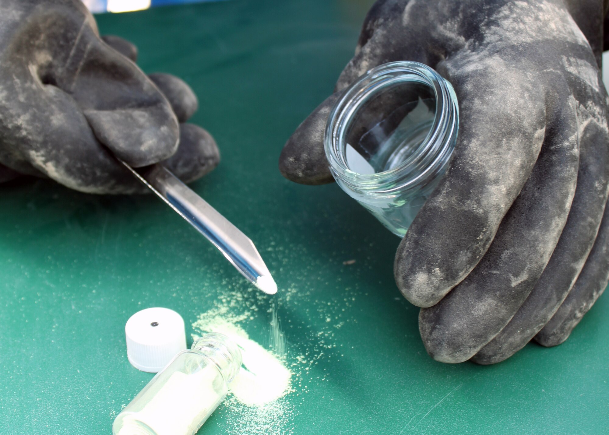 Senior Airman Nathan Krajcirik, 332nd Civil Engineer Squadron Emergency Management Section technician, takes a sample of an “unknown” powder during training Aug. 3, 2010, Joint Base Balad, Iraq.  Different powders, pastes, liquids and aerosols are frequently used in training, so that during a real-world incident EM Airmen are able to put their training to use. Airman Krajcirik, a native of Lansford, Penn., is deployed from Langley Air Force Base, Va. (U.S. Air Force photo/Staff Sgt. Stacy Fowler)
