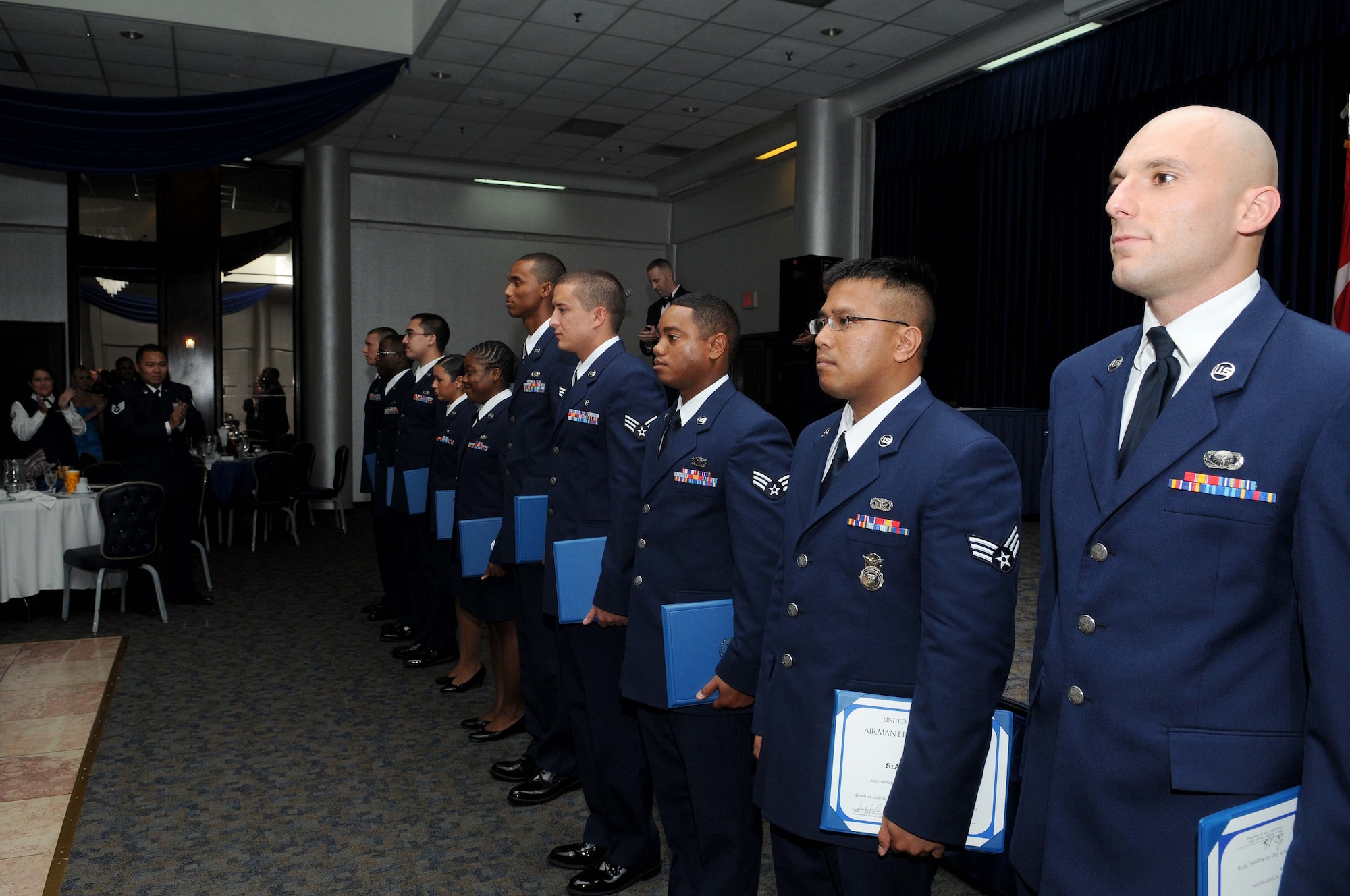 Ten Airmen graduate from Incirlik’s Airmen Leadership School at the consolidated club August 6, 2010 at Incirlik Air Base, Turkey.  The ALS graduates line up in front of the stage after receiving their diplomas.  Listed from front to back:  Senior Airman Eric Viola, Senior Airman Luther Rice, Senior Airman Alexandre Montes, Senior Airman Jonathan Hunt, Senior Airman Germaine Fields, Senior Airman Marquish Dixon, Senior Airman Gabriela Diaz, Senior Airman Alexander Campbell,  Staff Sgt. Marcus Brooks, and Staff Sgt. Nicholas Henry.  (U.S. Air Force photo/Senior Airman Ashley Wood)   