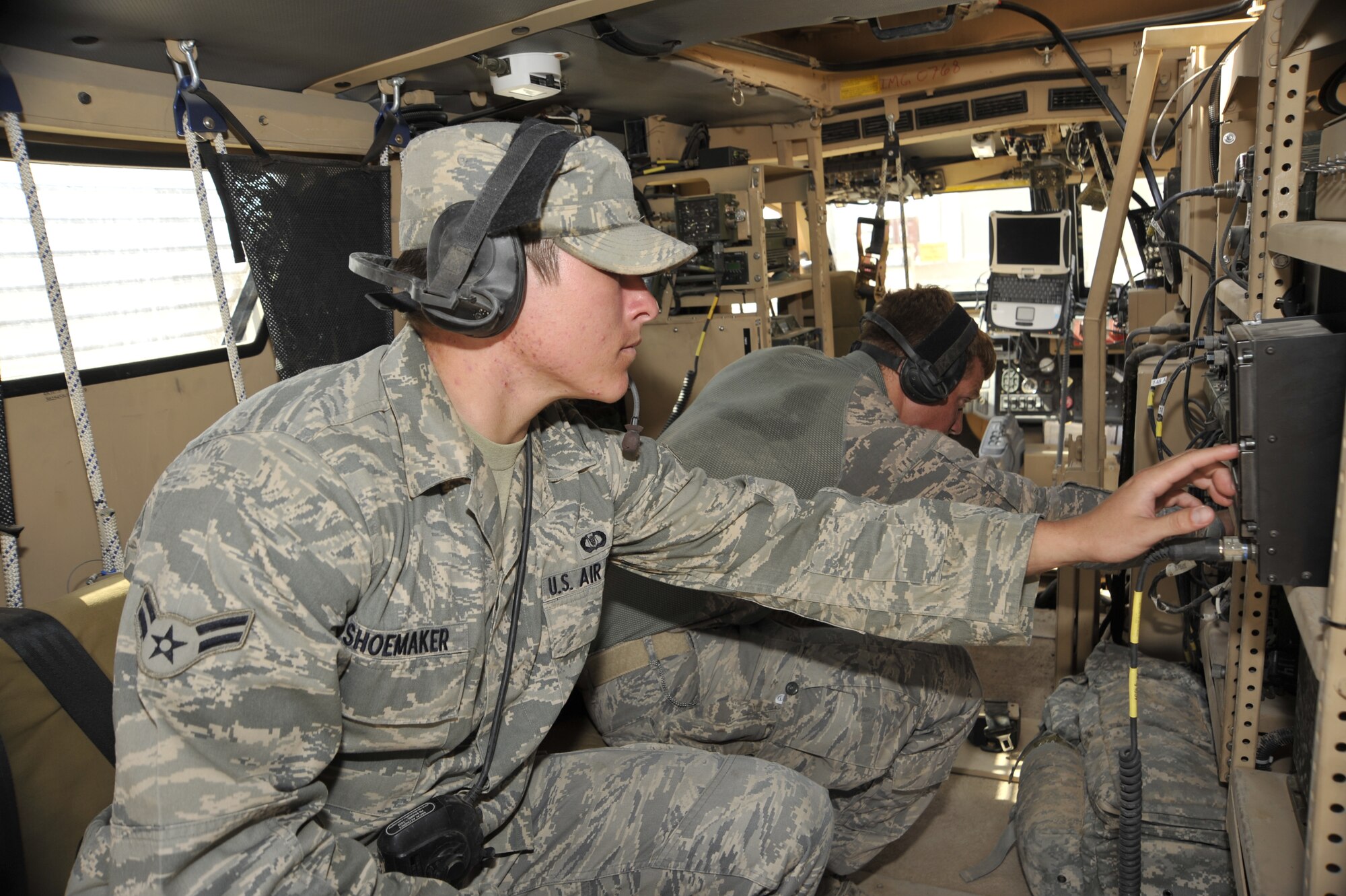 Senior Airman Donald McKee and Airman 1st Class John Shoemaker, both from the 82nd Air Support Operations Squadron Detachment 2, check radio equipment inside their mine resistant ambush protected vehicle, Aug. 3, 2010 at Camp Liberty, Iraq. Tactical air control party Airmen are performing pre-combat checks and inspections, to prepare to support the Responsible Drawdown of Forces mission, which is on track to bring the number of operational forces down to 50,000 troops. ( U.S. Air Force photo by Senior Airman Perry Aston) (Released)