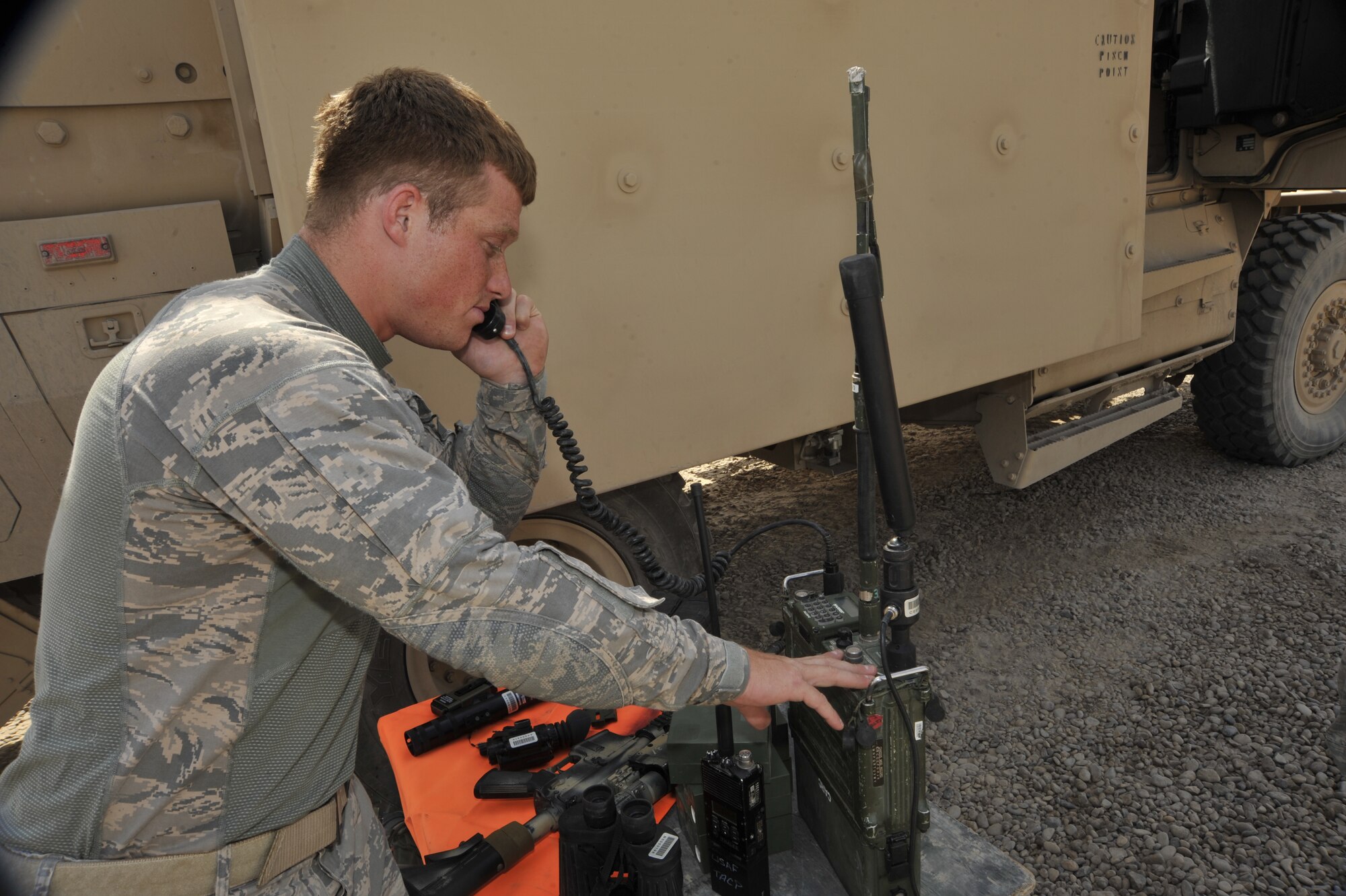 Senior Airman Donald McKee, 82nd Air Support Operations Squadron, Detachment 2, joint terminal attack controller, checks the operation of a radio, Aug. 3, 2010, at Camp Liberty, Iraq. Tactical air control party Airmen are performing pre combat check and inspections, to prepare to support the Responsible Drawdown of Forces mission, which is on track to bring the number of operational forces down to 50,000 troops. ( U.S. Air Force photo by Senior Airman Perry Aston) (Released)