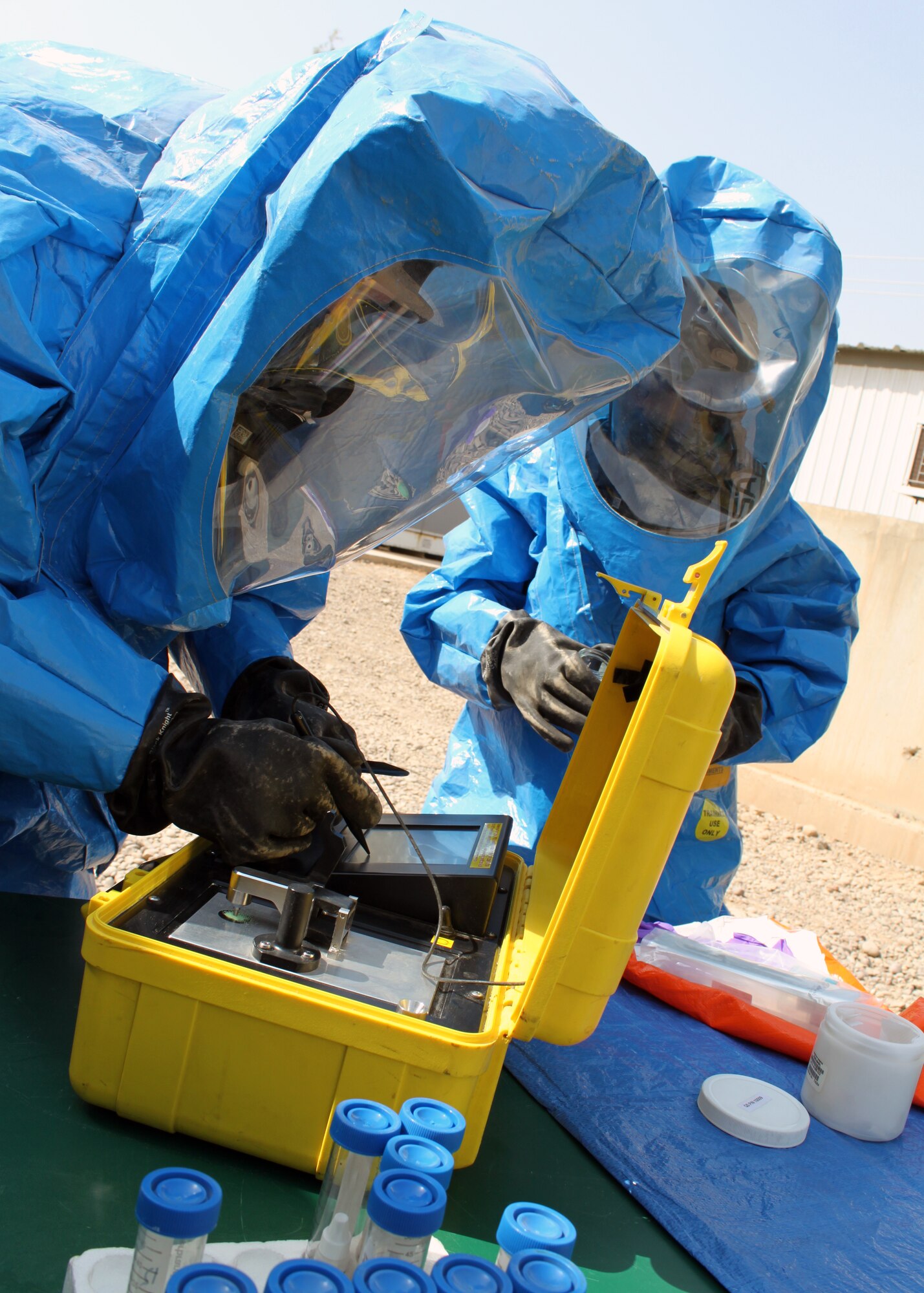 Senior Airmen Nathan Krajcirik (left) and Nadege James, 332nd Civil Engineer Squadron Emergency Management Section technicians, test a powder using a piece of equipment called “HAZMAT ID” during training Aug. 3, 2010, Joint Base Balad, Iraq.  A few weeks ago, Airmen from the EM section received a call to test some blue powder, which turned out to be chalk, unearthed during construction.  Airman Krajcirik, a native of Lansford, Penn., is deployed from Langley Air Force Base, Va.; Airman James, a native of Pompano Beach, Fla., is deployed from Nellis Air Force Base, Nev.  (U.S. Air Force photo/Staff Sgt. Stacy Fowler)
