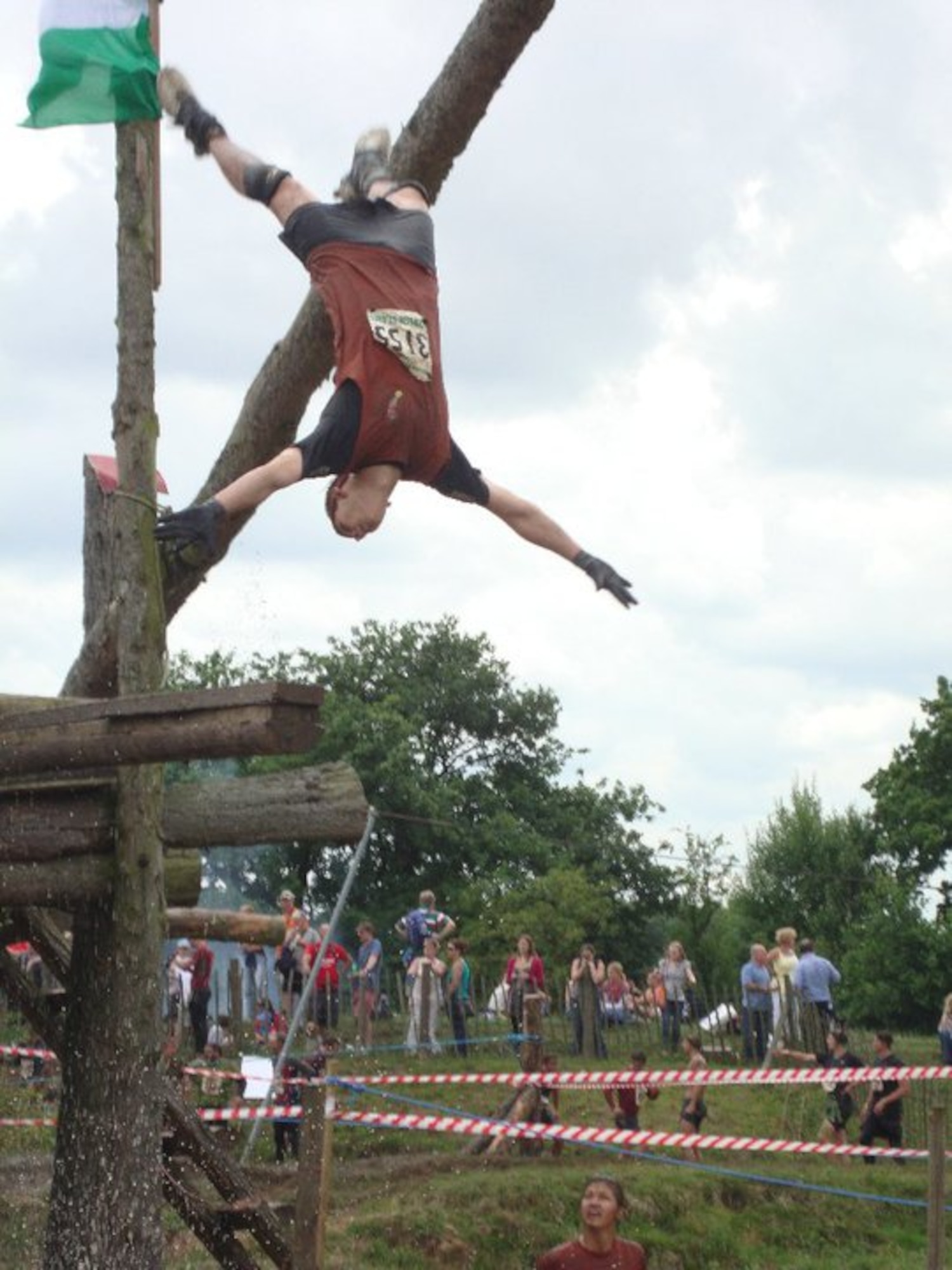 Petty Officer Brandon T. Duvall takes an unusual approach to a water obstacle during the UK TOUGH GUY/NETTLE WARRIOR competition in Perton England.  Duvall completed the course on July 25th as part of the JAC HAMMERS team from RAF Molesworth.  U.S. Air Force Photo by Staff Sgt. Kathleen B. Thorburn