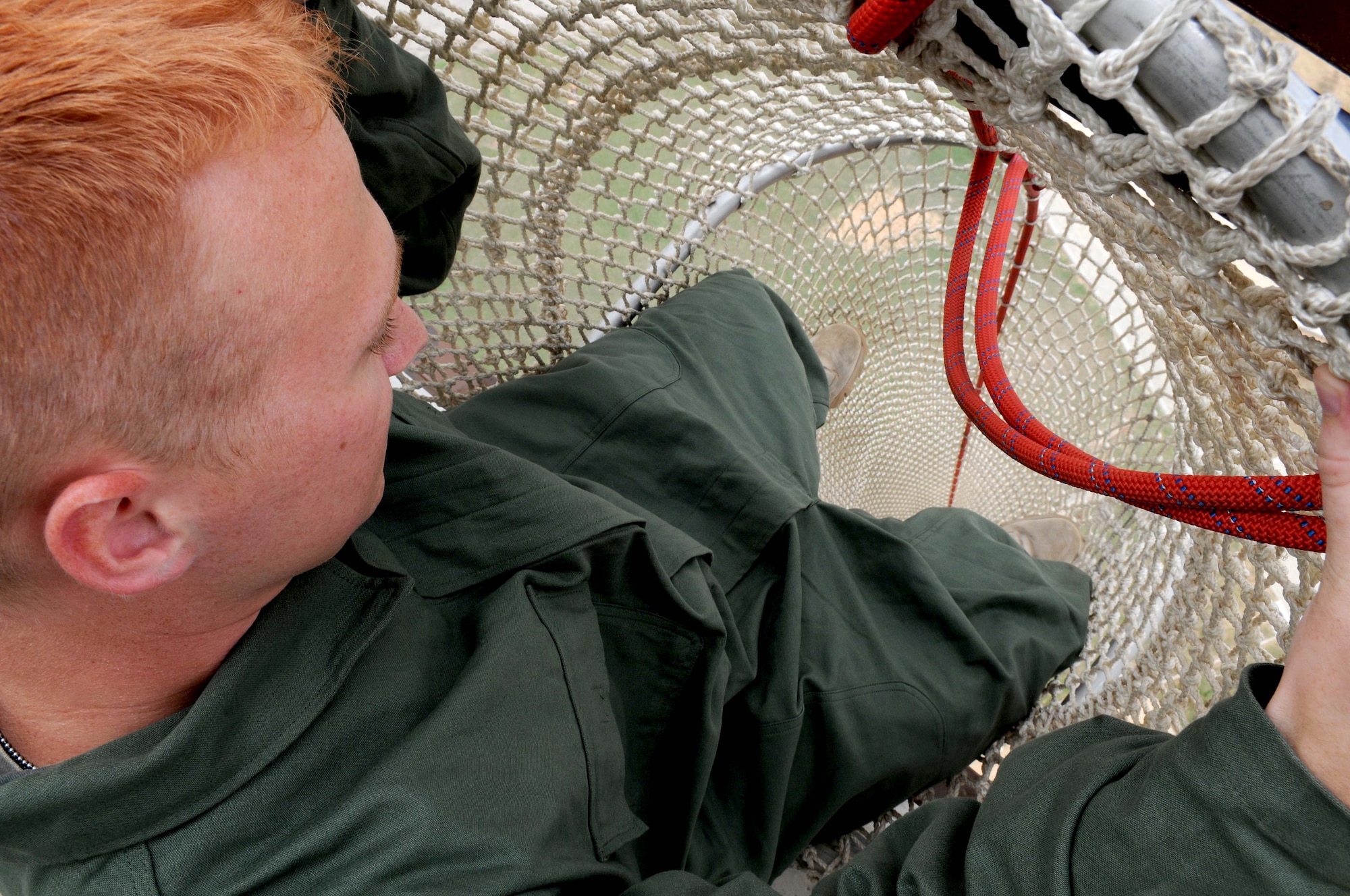 Senior Airman Aaron Johnson, 39th Air Base Wing public affairs, prepares to slide down the Baker Life Chute at the top of the air traffic control tower August 6, 2010 at Incirlik Air Base, Turkey.  The chute is a secondary means of evacuation in case of an emergency and takes less than 30 seconds to slide down.  (U.S. Air Force photo/Senior Airman Ashley Wood)