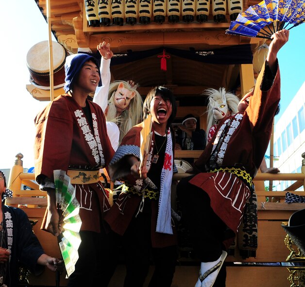 YOKOTA AIR BASE, Japan -- Performers dance and sing during the Fussa Tanabata Festival Aug. 6. The festival itself featured a number of different groups carrying Mikoshi (shrines) and mobile stages featuring performances of traditional Japanese characters such as a fox and an Oni, or a demon. At many points during the march the groups would raise the shrines and cheer in front of the stages. The festival included performances of traditional Japanese dancing and the carrying of shrines from Shinmeisya Shrine to Fussa City Hall (U.S.Air Force photo/Staff Sgt. Stacy Moless)
