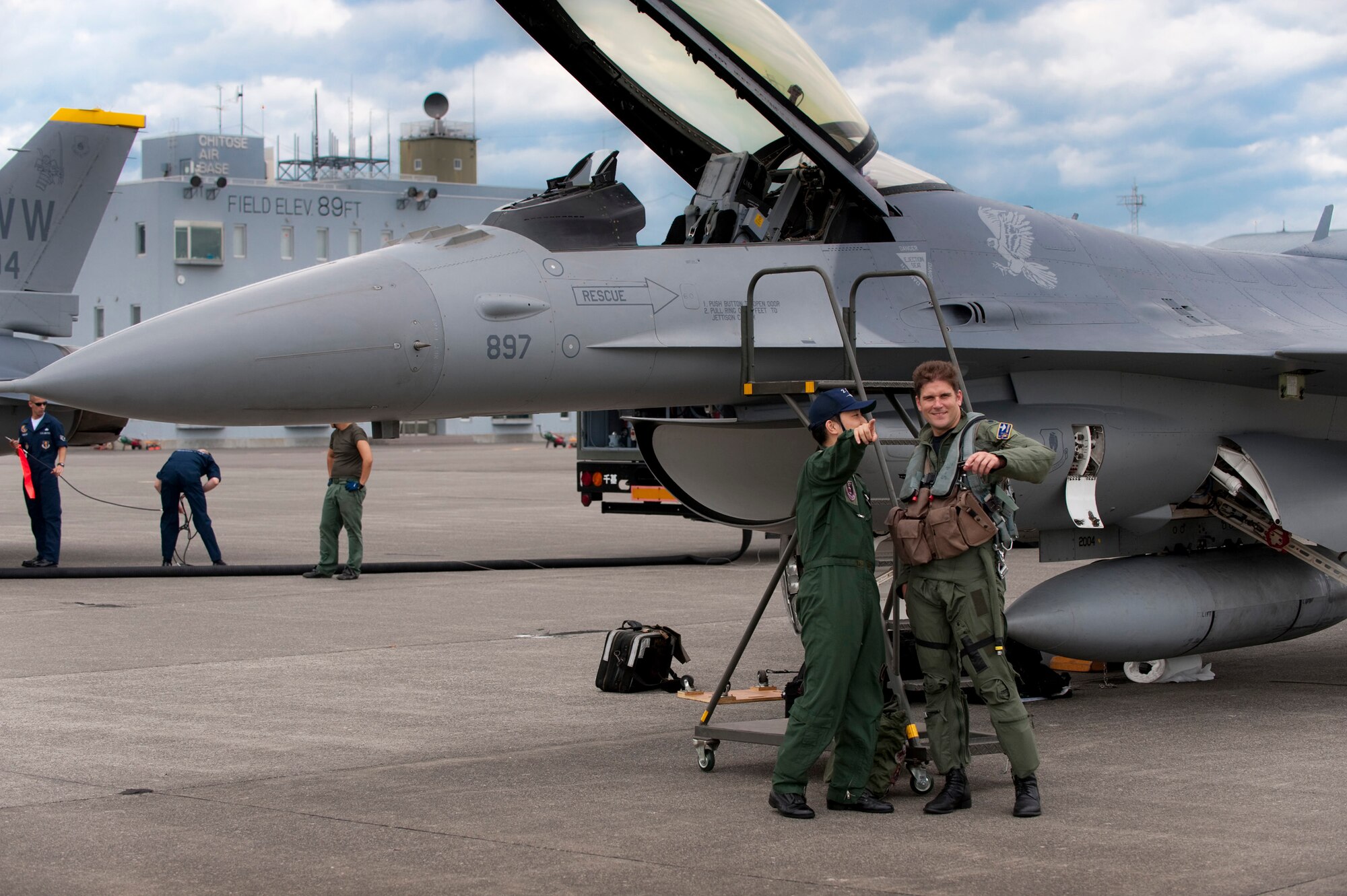 CHITOSE AIR BASE, Japan -- Lt. Col. David Youtsey, Pacific Air Forces Demonstration Team safety observer, talks with Japan Air Self-Defense Force 1st Lt. Tadahiko Tashiro, 201st Fighter Squadron pilot, after landing at Chitose Air Base Aug. 6 (U.S. Air Force photo/Staff Sgt. Samuel Morse)