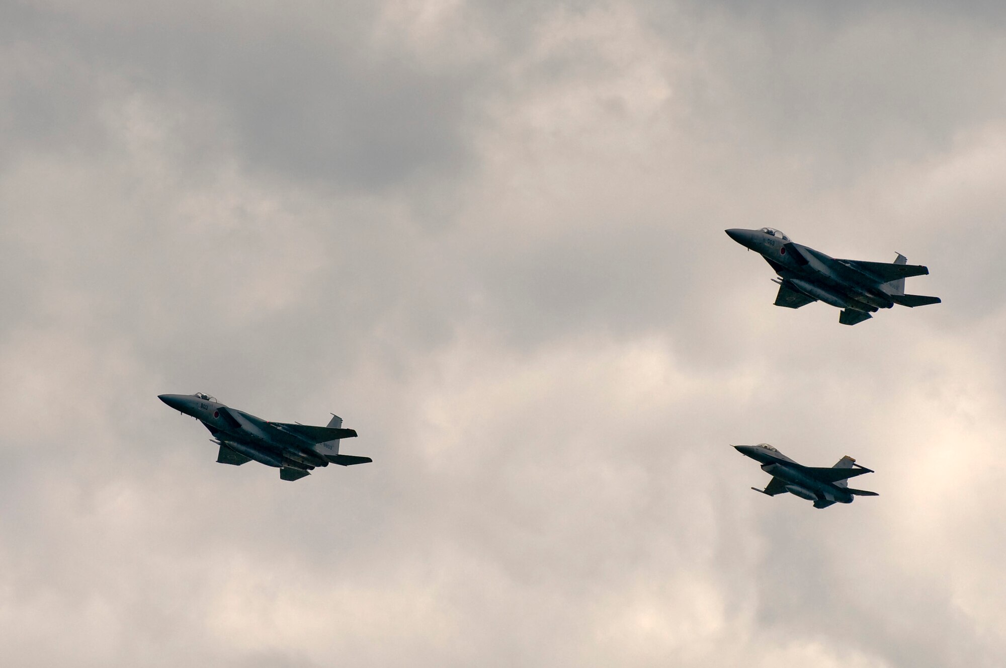 CHITOSE AIR BASE, Japan -- Lt. Col. Dylan Baumgartner, Pacific Air Forces Demonstration Team pilot, flies an F-16 Fighting Falcon in formation with two Japan Air Self-Defense Force F-15 Eagles Aug. 6. The JASDF invited the American team to their Chitose Air Festival Aug. 8. (U.S. Air Force photo/Staff Sgt. Samuel Morse)