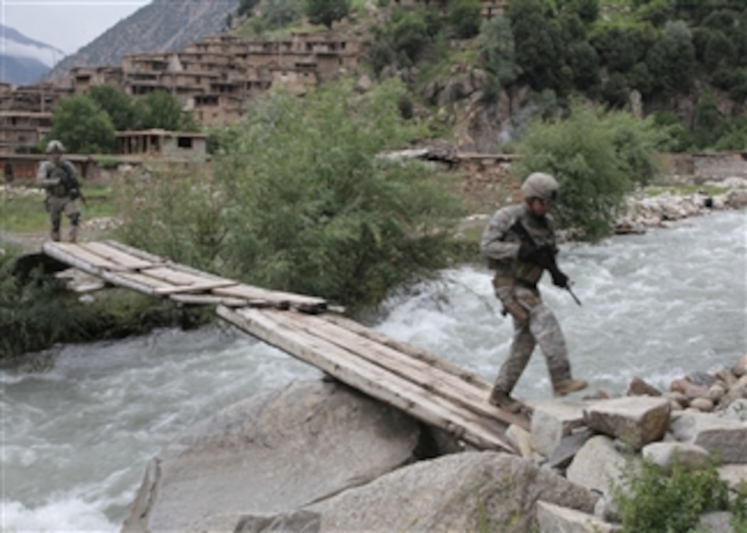 U.S. Army soldiers from 1st Battalion, 327th Infantry Regiment, 101st Airborne Division advance through the town of Barge Matal as part of Operation Azmaray Fury in Kunar province, Afghanistan, on July 30, 2010.  