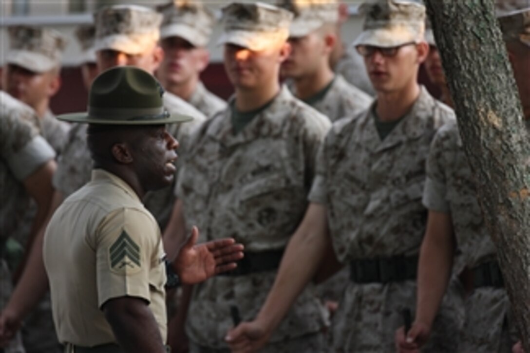 U.S. Marine Corps recruits attached to Platoon 3052, Lima Company, 3rd Battalion stand at parade rest while Sgt. Harold Shade (left) talks during final drill on the Peatross Parade Deck at Marine Corps Recruit Depot Parris Island, S.C., on Aug. 4, 2010.  