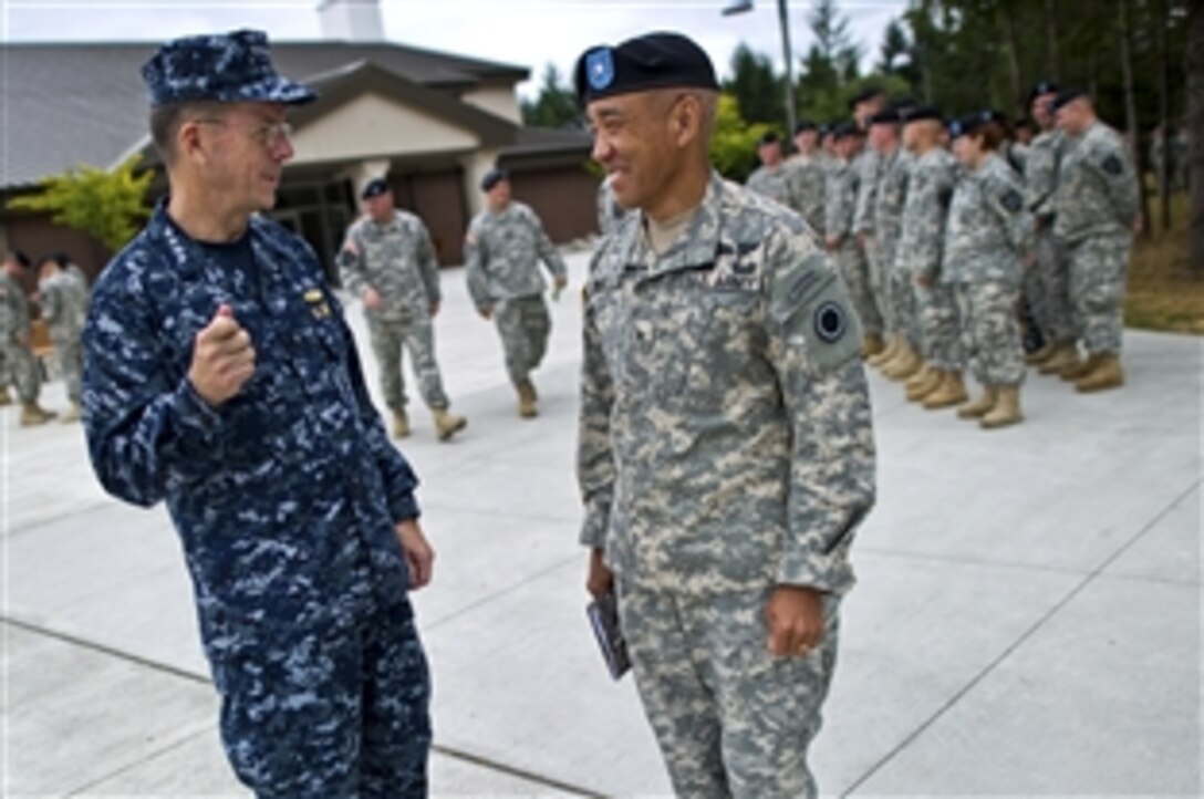 U.S. Navy Adm. Mike Mullen, left, chairman of the Joint Chiefs of Staff, speaks with U.S. Army Brig. Gen. Loyd Miles, deputy commander of I Corps, after an all-hands call with the 2nd Infantry Division's 2nd Stryker Brigade Combat Team on Joint Base Lewis-McChord, Wash., Aug. 9, 2010.







