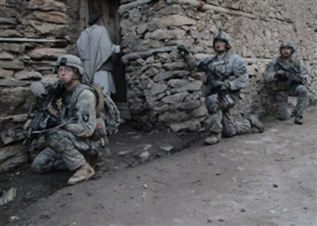 U.S. Army soldiers from 1st Battalion, 327th Infantry Regiment, 101st Airborne Division kneel outside the town of Badmuk, Kunar province, Afghanistan, after a night assault on suspected Taliban positions as part of Operation Azmaray Fury on Aug. 2, 2010.  