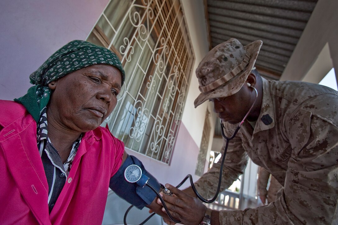 U.S. Navy Petty Officer 3rd Class Godfrey Aneke, a hospital corpsman with 2nd Battalion, 25th Marine Regiment, takes the blood pressure of a Mozambican women Aug. 11, 2010. Aneke, a native of Nigeria, helped other U.S. service members during a medical civil assistance program as part of exercise Shared Accord 2010. SHARED ACCORD is an annually scheduled, bi-lateral U.S.-Mozambique field training exercise aimed at conducting small unit infantry and staff training with U.S. Africa Command partner nations. The exercise is designed to increase partner nation capacity for conducting peace and stability operations.