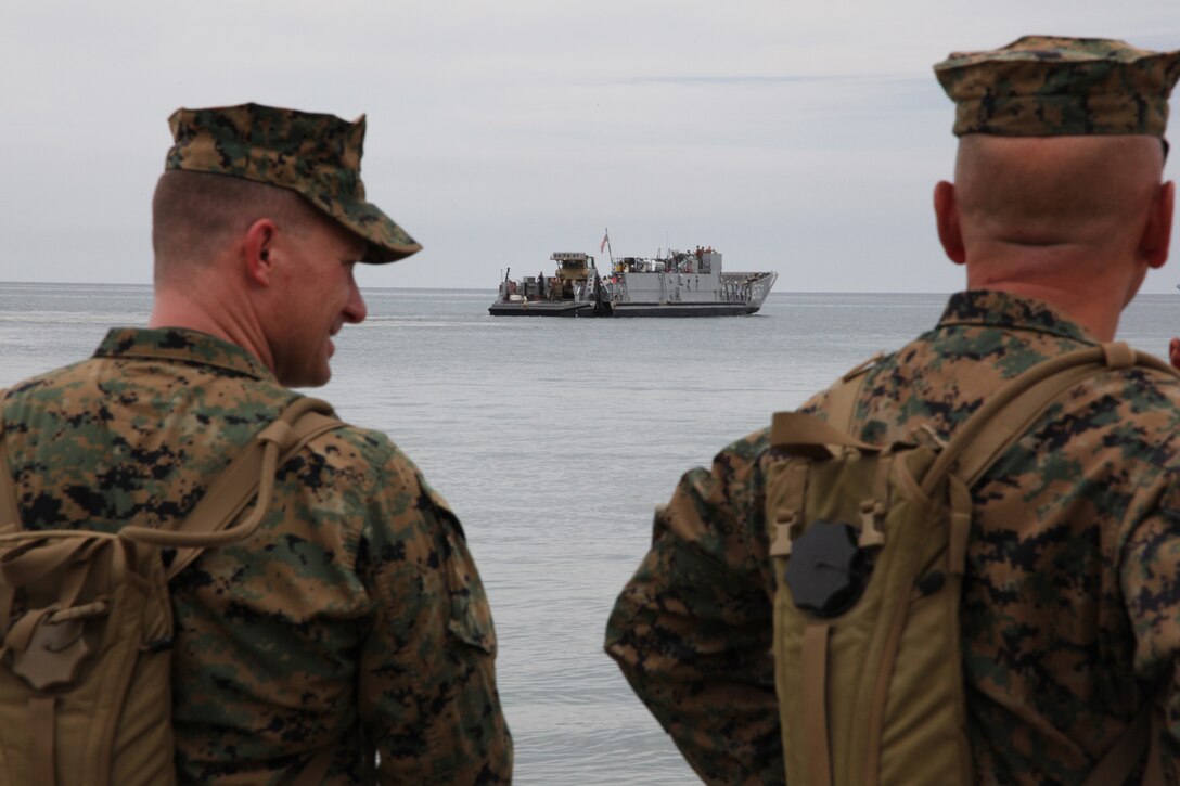 (From left) Lt. Col. Chris S. Richie, commanding officer of Special-Purpose Marine Air-Ground Task Force Continuing Promise 2010, and Sgt. Maj. William R. Sweet, sergeant major of Special-Purpose MAGTF, observe  a landing craft utility make way to the USS Iwo Jima in Covenas, Colombia, Aug. 10, 2010. The mission of CP10 is to conduct civil-military operations including subject matter expert exchanges, humanitarian civic assistance and disaster relief to partner nations to the Caribbean, Central and South America. (Marine Corps photo by Cpl. Alicia R. Giron)