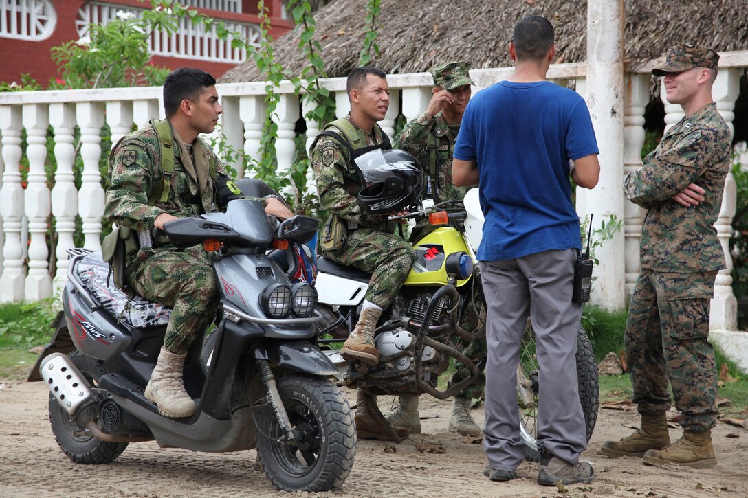Capt. Michael C. Toth, the legal attorney with Marine Air Control Squadron 2, Command Element of Special-Purpose Marine Air-Ground Task Force Continuing Promise 2010, talks to Colombian Marines upon arrival in Covenas, Colombia, Aug. 10, 2010. Marines will conduct subject matter expert exchanges with Colombian Marines. The mission of CP10 is to conduct civil-military operations including subject matter expert exchanges, humanitarian civic assistance and disaster relief to partner nations to the Caribbean, Central and South America.