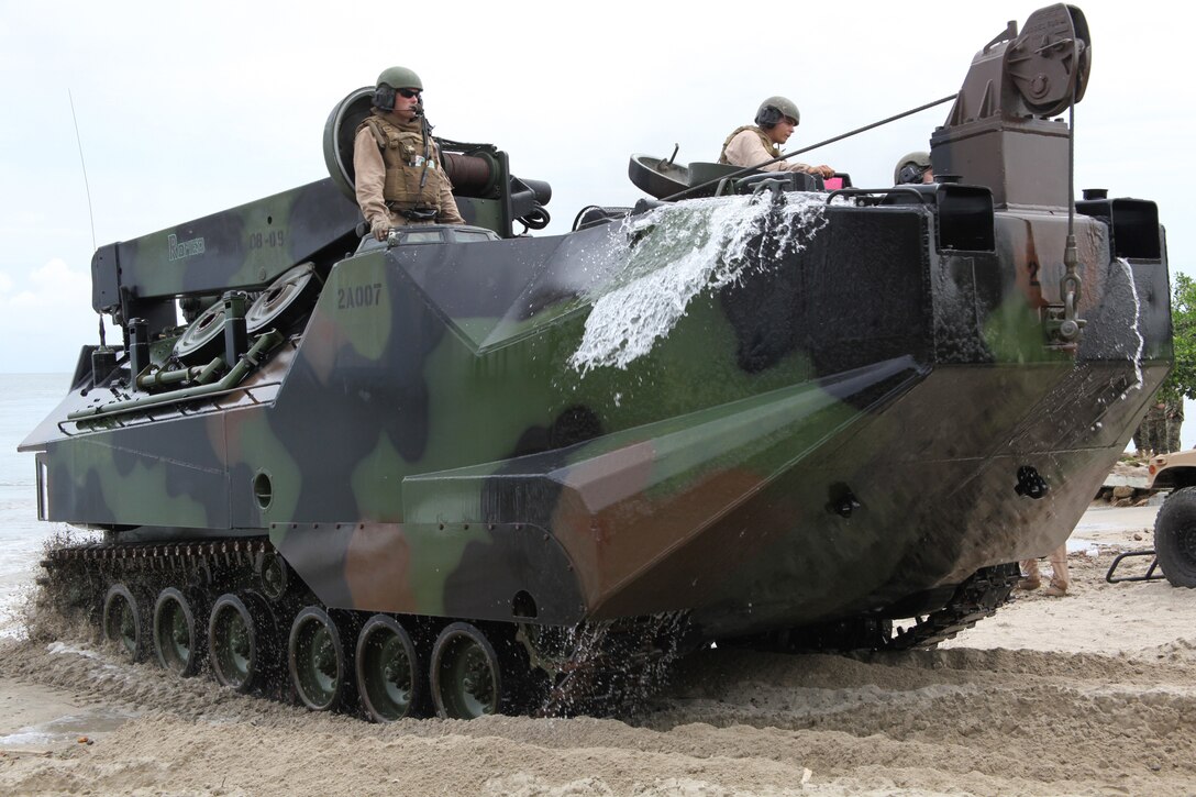 Marines with Company A, 2nd Assault Amphibian Battalion, Ground Combat Element of Special-Purpose Marine Air-Ground Task Force, Continuing Promise 2010, maneuver an amphibious assault vehicle onto a beach in Covenas, Colombia, Aug. 10, 2010, in preparation for subject matter expert exchanges with Colombian Marines. The mission of CP10 is to conduct civil-military operations including subject matter expert exchanges, humanitarian civic assistance and disaster relief to partner nations to the Caribbean, Central and South America. (Marine Corps photo by Cpl. Alicia R. Giron)