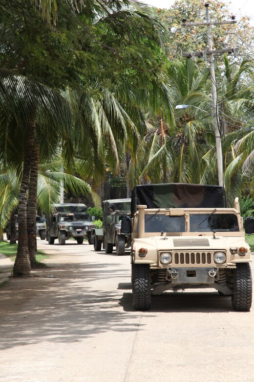 Marines with Company A, 2nd Assault Amphibian Battalion, Ground Combat Element of Special-Purpose Marine Air-Ground Task Force Continuing Promise 2010, convoy Humvees to stage their vehicles and gear at Colombian Marine Corps Training Base Covenas in Colombia, Aug. 10, 2010, in preparation for subject matter expert exchanges with Colombian Marines. The mission of CP10 is to conduct civil-military operations including subject matter expert exchanges, humanitarian civic assistance and disaster relief to partner nations to the Caribbean, Central and South America. (Marine Corps photo by Cpl. Alicia R. Giron)
