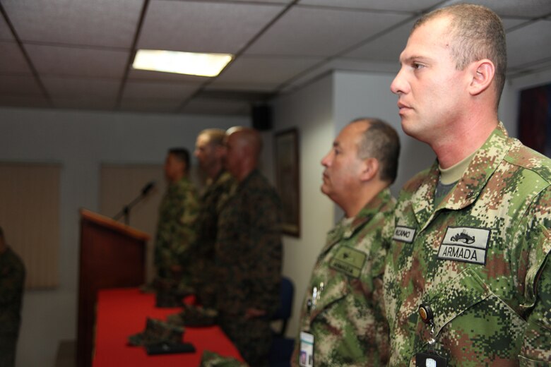 Colombian Marine Capt. Nelson Cano and Sgt. Maj. Juan Carlos Orjuela stand with fellow Colombian and U.S. Marines as the Colombian national anthem is played during an opening ceremony at Colombian Marine Corps Training Base Covenas in Colombia, Aug. 10, 2010, as the start of joint military subject matter expert exchanges with Colombian and U.S. Marines as part of Continuing Promise 2010. The mission of CP10 is to conduct civil-military operations including subject matter expert exchanges, humanitarian civic assistance and disaster relief to partner nations to the Caribbean, Central and South America. (Marine Corps photo by Cpl. Alicia R. Giron)