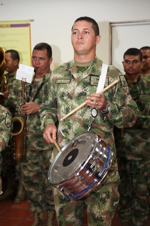 A Colombian Marine drums the beat of the Colombian national anthem during an opening ceremony at Colombian Marine Corps Training Base in Colombia, Aug. 10, 2010, as the start of joint military subject matter expert exchanges with Colombian and U.S. Marines as part of Continuing Promise 2010. The mission of CP10 is to conduct civil-military operations including subject matter expert exchanges, humanitarian civic assistance and disaster relief to partner nations to the Caribbean, Central and South America. (Marine Corps photo by Cpl. Alicia R. Giron)