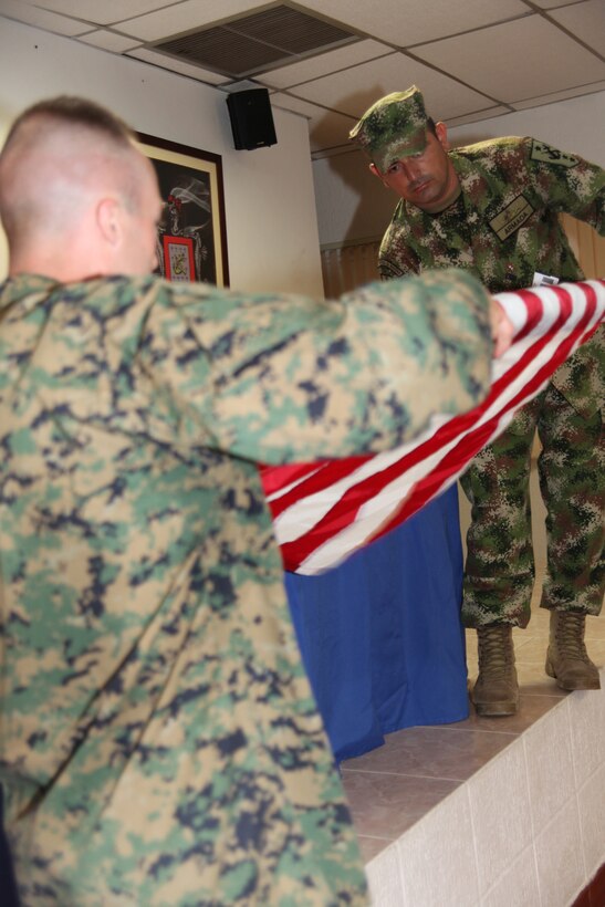1st Lt. Darren M. Beatty, native of Quince, Calif., and assistance operations officer with Marine Air Control Squadron 2, Command Element of Special-Purpose Marine Air-Ground Task Force Continuing Promise 2010, assists Colombian Marine Sgt. Vice Wilmar Jose Primero Ibarra fold the American flag after an opening ceremony at Colombian Marine Corps Training Base Covenas in Colombia, Aug. 10, 2010, as the start of joint military subject matter expert exchanges with Colombian and U.S. Marines as part of Continuing Promise 2010. The mission of CP10 is to conduct civil-military operations including subject matter expert exchanges, humanitarian civic assistance and disaster relief to partner nations to the Caribbean, Central and South America. (Marine Corps photo by Cpl. Alicia R. Giron)