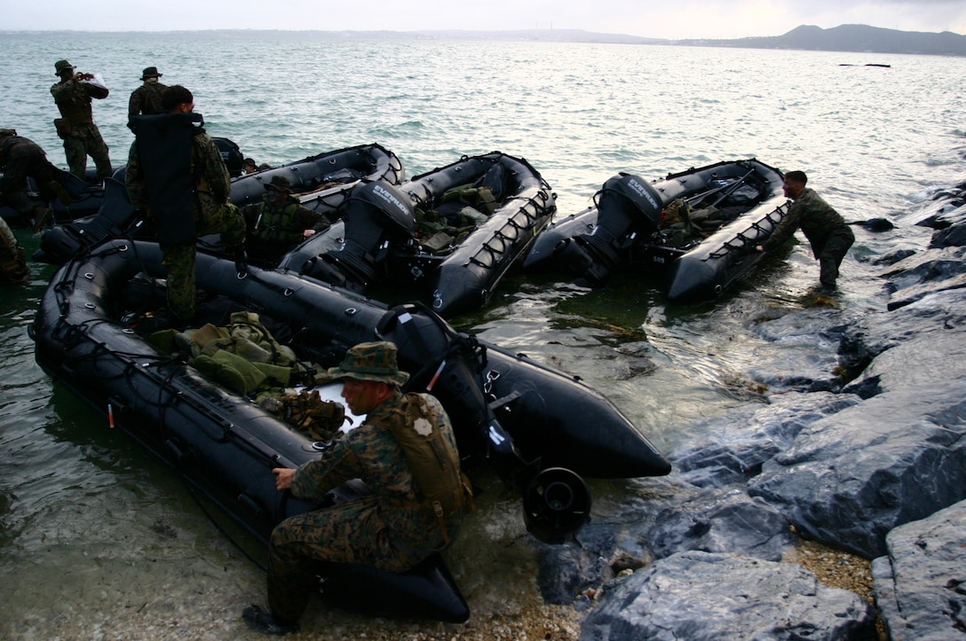 Marines with Company B, Battalion Landing Team  1st Battalion, 7th Marines, 31st Marine Expeditionary Unit, prepare to  launch Combat Rubber Raiding Crafts prior to conducting  a simulated boat raid, Aug. 10. The boat raid was in support of the MEU’s preparation for its upcoming fall patrol.