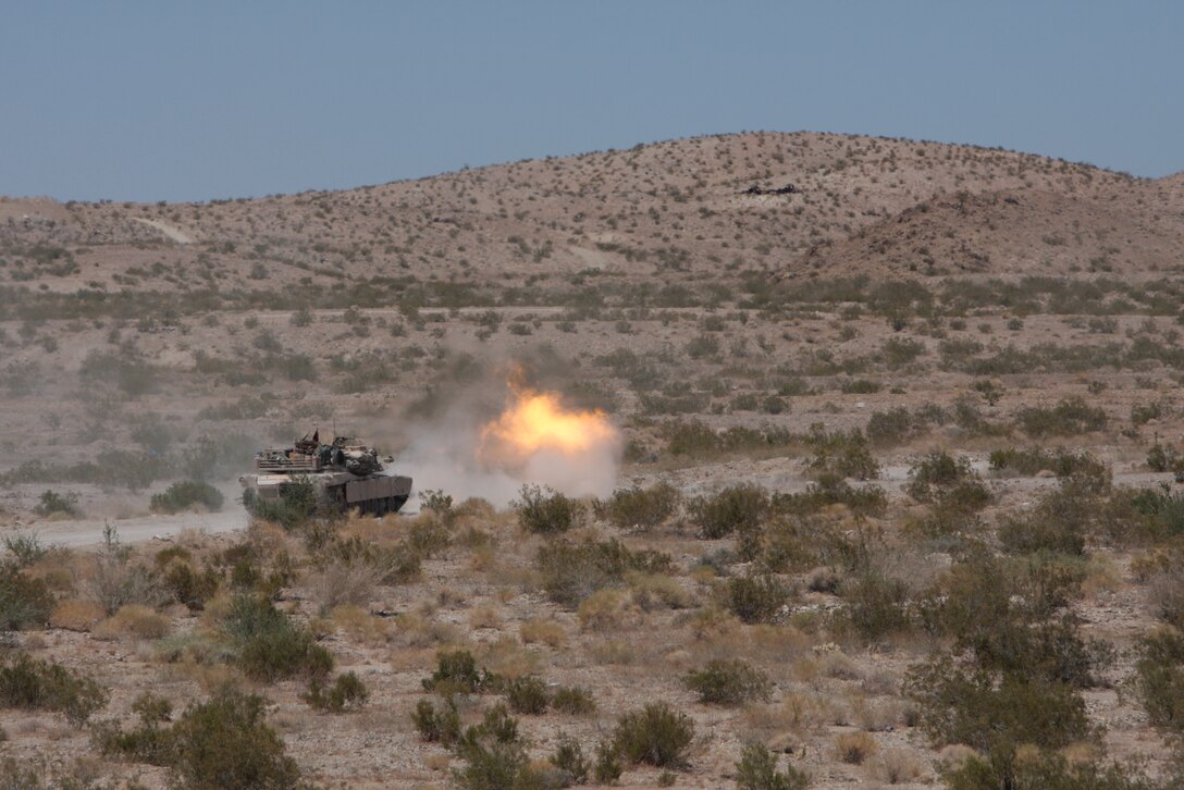 A 1st Platoon, Company D, 1st Tank Battalion, M1A1 Abrams Main Battle Tank fires its cannon during the platoon’s first gunnery qualification Aug. 10 at Combat Center range 500.