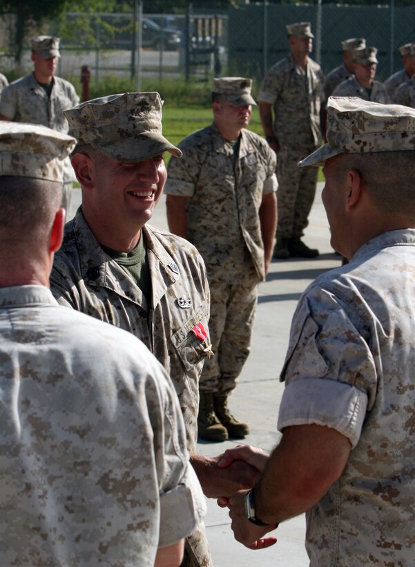 Gunnery Sgt. Drew B. Jordan, an Explosive Ordnance Disposal technician with EOD Company, 8th Engineer Support Battalion, 2nd Marine Logistics Group, receives a Bronze Star Medal with a Combat Distinguishing Device during an award ceremony aboard Camp Lejeune, N.C., Aug. 10, 2010.  Brig. Gen. Michael G. Dana, the 2nd MLG commanding general, presented the awards to the Marines.   (U.S. Marine Corps photo by Lance Cpl. Bruno J. Bego)
