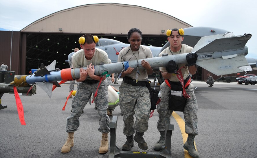(L-R)Airman 1st Class Joshua Becker, Senior Airman Ivori Coleman, and Staff
Sgt. Kevin McCain, 51st Maintenance Squadron, load an air-to-air missile
onto an F-16 aircraft in the quarterly weapons load crew competition, at
Osan Air Base, Republic of Korea, Aug. 6. (U.S. Air Force Photo/Senior
Airman Evelyn Chavez)
