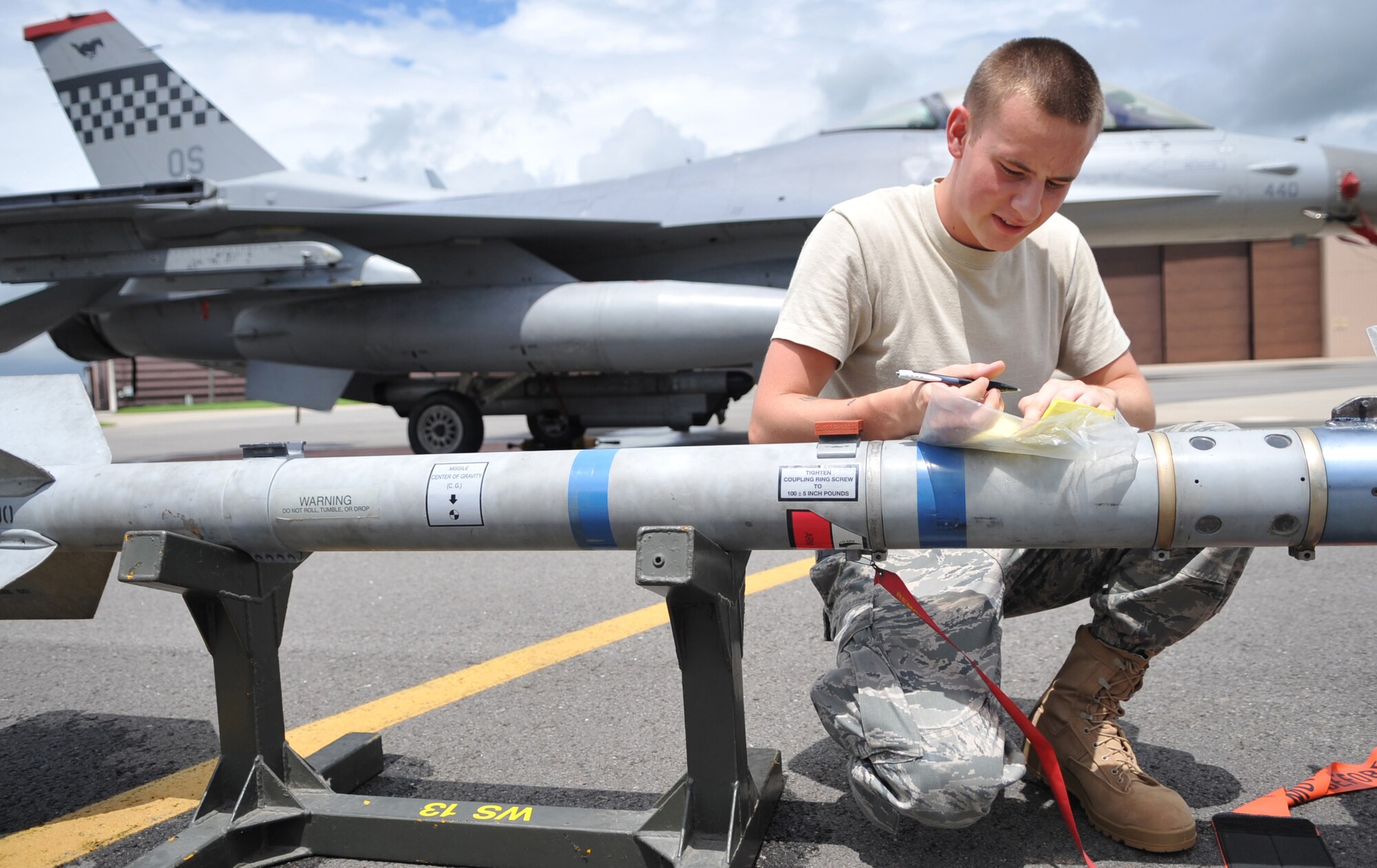 Airman 1st Class Joshua Becker, 51st Aircraft Maintenance Squadron, preps munition during the quarterly load competition at Osan Air Base, Republic of Korea Aug. 6.  Weapons load teams from 36th and 25th Aircraft Maintenance Units also completed a 25 question test and a dress and personal appearance inspection. (U.S. Air Force Photo/Senior Airman Evelyn Chavez)