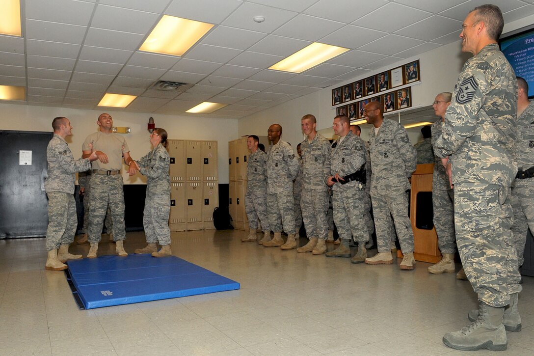 LANGLEY AIR FORCE BASE, Va -- Air Combat Command Chief Master Sgt. Martin Klukas watches as 633d Security Forces Airmen demonstrate the feel of being tased during a base tour Aug. 10. Chief Klukas toured the base Aug. 9 and 10, interacting with the Airmen of all squadrons to better understand their work force and needs. (U.S. Air Force photo/Staff Sgt. Ashley Hawkins)(RELEASED)