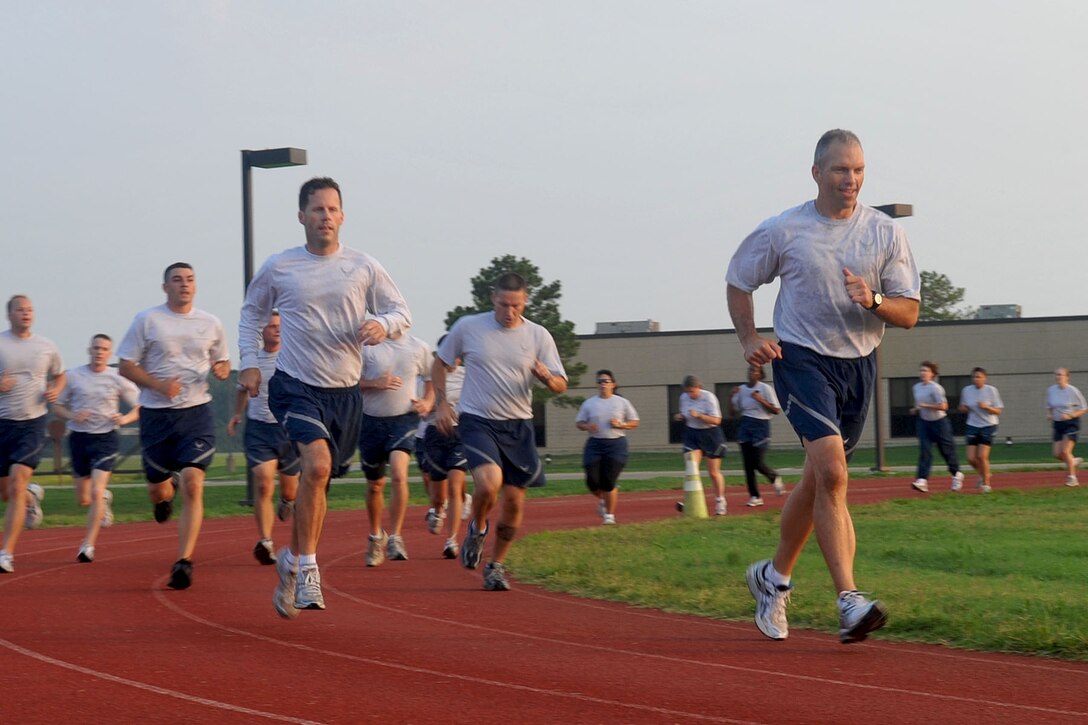 LANGLEY AIR FORCE BASE, Va -- Air Combat Command Chief Master Sgt. Martin Klukas runs a lap during physical training with the 633d Air Base Wing staff Aug. 10. Chief Klukas toured the base Aug. 9 and 10, interacting with the Airmen of all squadrons to better understand their work force and needs. (U.S. Air Force photo/Staff Sgt. Ashley Hawkins)(RELEASED)