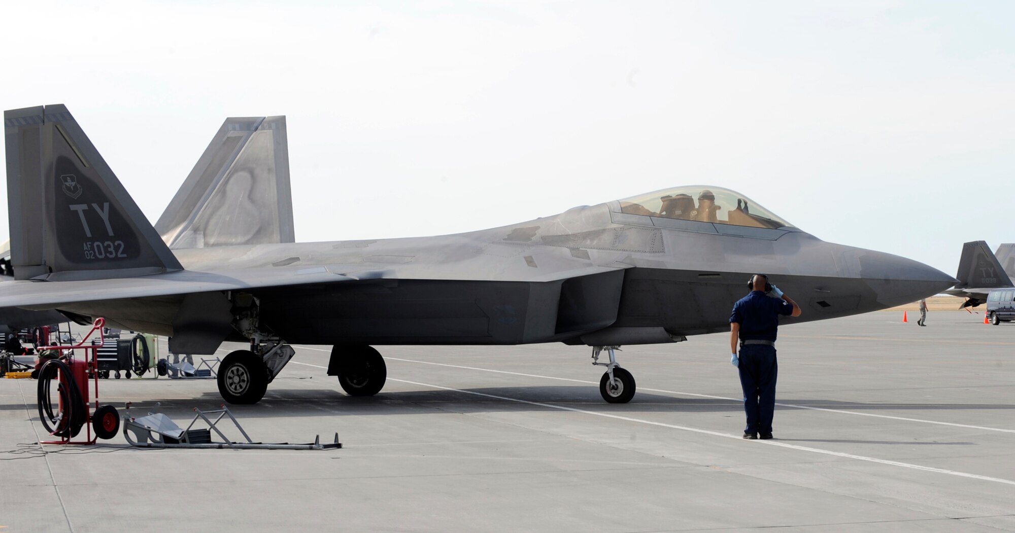 MOUNTAIN HOME AIR FORCE BASE, Idaho -- Senior Airman Dez Watson, 43rd
Aircraft Maintenance Unit crew chief, out of Tyndall AFB, Fla., salutes an
F-22 Raptor as it taxis toward the Mountain Home AFB runway Aug 6. More than 150 Airmen and 12 F-22 Raptors from the 43rd Fighter Squadron, Tyndall Air Force Base, Fla., arrived here July 31 in support of the Air Force’s first Exercise Global Gem joint training. (U.S. Air Force photo by Airman 1st Class Debbie Lockhart)