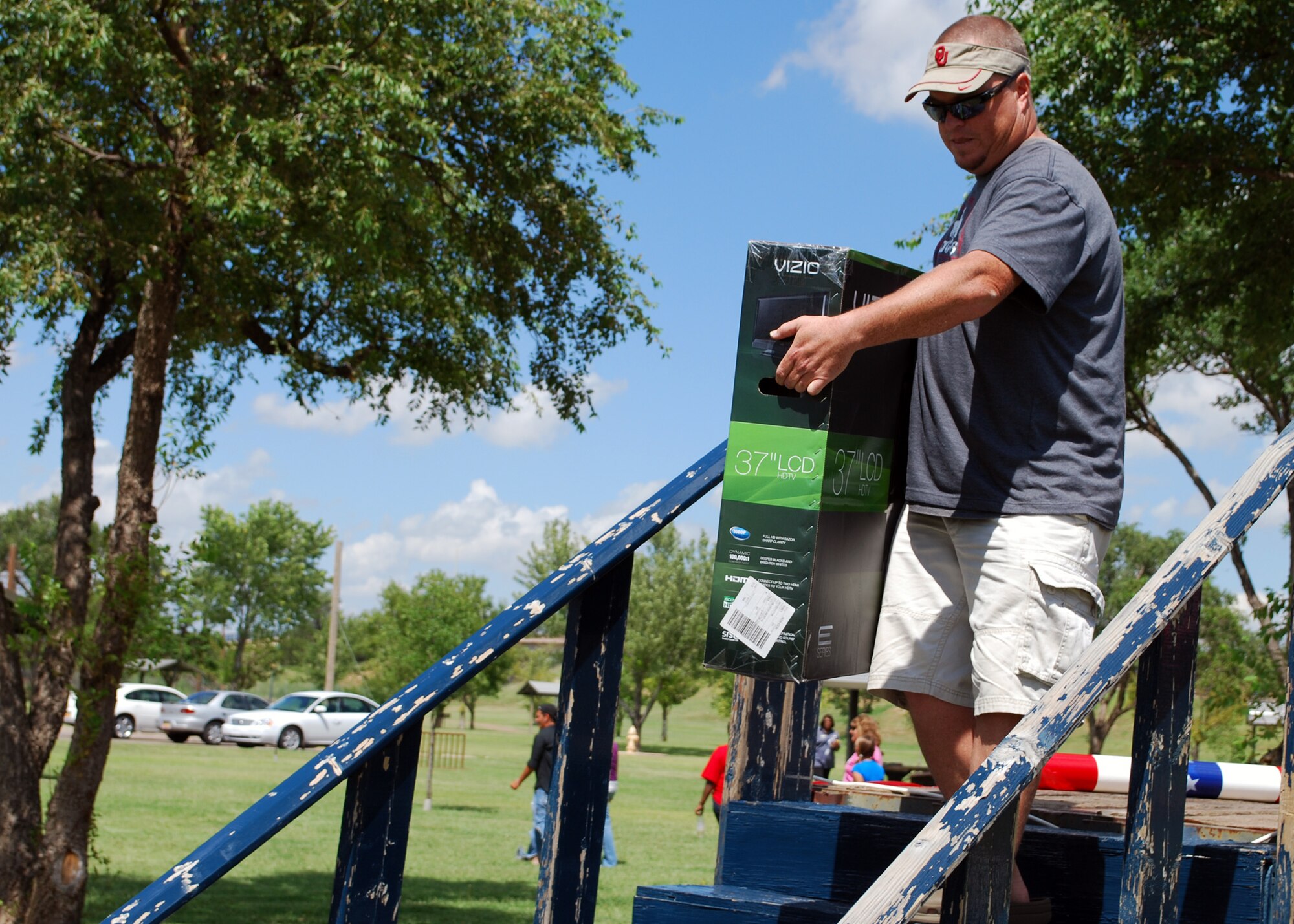 Danny Kernan, an air traffic controller with the 27th Special Operations Support Squadron, walks off the prize stage with a 37-inch HDTV during Cannon Appreciation Day Aug. 6, 2010. Prizes totaling $4,000 were won by Cannon Airmen, their families and civilian workers at Cannon Air Force Base, N.M. (U.S. Air Force photo by 2nd Lt. Stephanie Strine)

