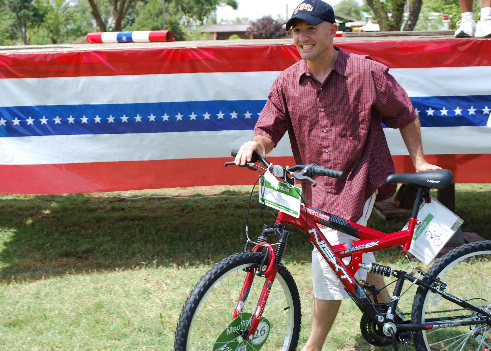 U. S. Air Force Tech. Sgt. Chris Porter, 27th Special Operations Aerospace Medicine Squadron, is all smiles as he walks off with his new mountain bike that he won in a raffle at Cannon Appreciation Day, Aug. 6, 2010.  The Committee of 50, the Clovis Chamber of Commerce, and the Clovis Economic Development Committee hosted the event that included $4,000 in raffle prizes.  (U.S. Air Force photo by 2nd Lt. Stephanie Strine)