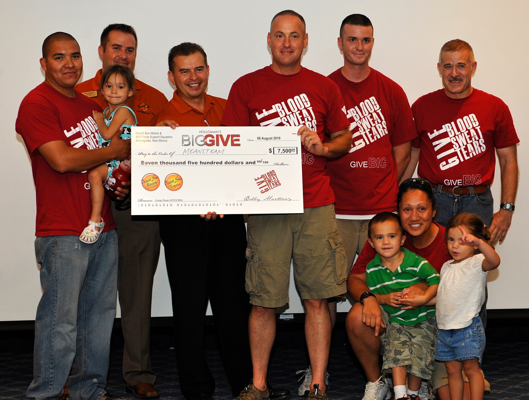 HOLLOMAN AIR FORCE BASE, N.M.  -- Members from the Big Give team, Meansteam, pose for a group photo after winning the large team give Big Give Award at the Desert Sands Enlisted Club, Aug. 6, 2010. Meansteam won $7,500 sponsored by Desert Sun Motors for their two projects: re-roofing the Father B. Hay Preschool and a major renovation of the Veterans' of Foreign Wars office. (U.S. Air Force photo by Senior Airman Veronica Stamps / Released)