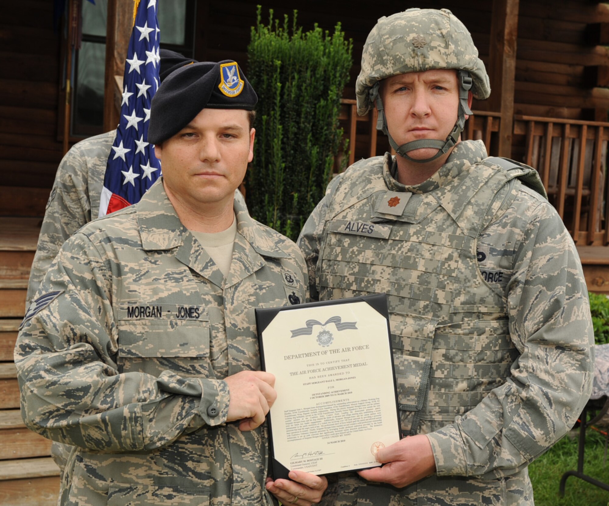 SEYMOUR JOHNSON AIR FORCE BASE, N.C. – Maj. Jim Alves presents Senior Airman Michael Hampton an Air Force Achievement Medal here Aug. 6, 2010. Staff Sgt. Dale Morgan-Jones served as a military working dog handler with the 455th Expeditionary Security Forces Squadron, Bagram Airfield, Afghanistan. He and Kery, his German Sheppard canine partner, served as a deterrent to help suppress a violent riot involving more than 100 Afghanis. He also worked with explosive ordinance personnel to set-up joint training exercises with locally produced explosives to increase canine detection proficiency. Major Alves is the 4th Security Force Squadron commander. (U.S. Air Force photo/Senior Airman Gino Reyes)