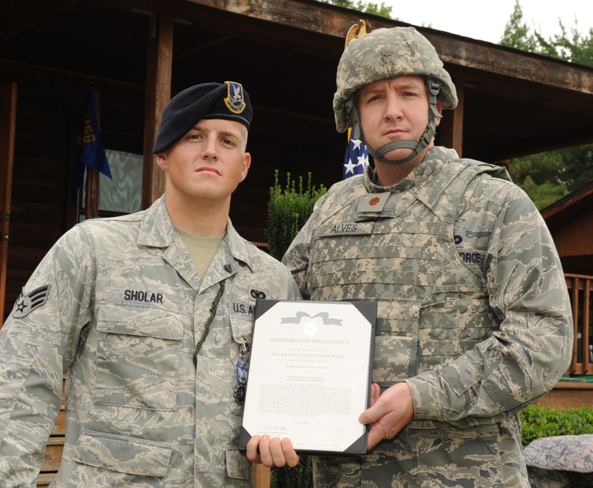 SEYMOUR JOHNSON AIR FORCE BASE, N.C. – Maj. Jim Alves presents Senior Airman Daniel Sholar an Air Force Achievement Medal here Aug. 6, 2010. Airman Sholar deployed to the 451st Expeditionary Security Forces Squadron, at Kandahar Air Base, Afghanistan. As a vehicle operator and primary medical liaison, he aided in the delivery of more than 4,000 pounds of humanitarian aid to 200,000 Afghan citizens in 99 villages, bolstering public confidence and aiding in the collection of critical intelligence in Kandahar Province. Major Avles is the 4th Security Force Squadron commander. (U.S. Air Force photo/Senior Airman Gino Reyes)