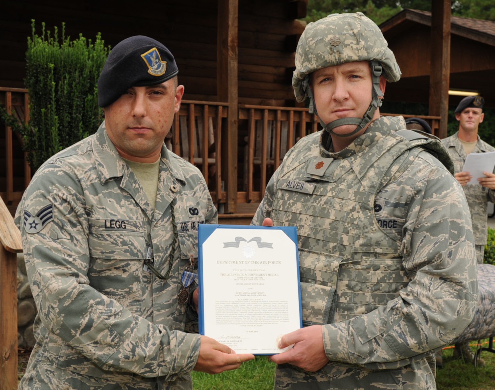 SEYMOUR JOHNSON AIR FORCE BASE, N.C. – Maj. Jim Alves presents Senior Airman Dino Legg with his first Air Force Achievement Medal oak leaf cluster here Aug. 6, 2010. Airman Legg deployed to the 451st Expeditionary Security Forces Squadron, at Kandahar Air Base, Afghanistan. He provided protection, as a .50 caliber machine gunner, for his team and 10 agents during 115 combat missions stretching more than 3,000 miles. Major Avles is the 4th Security Force Squadron commander. (U.S. Air Force photo/Senior Airman Gino Reyes)