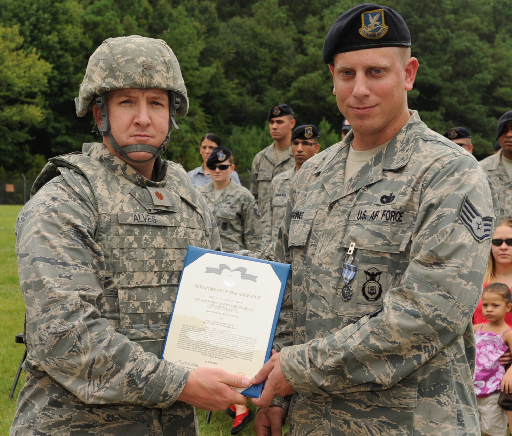 SEYMOUR JOHNSON AIR FORCE BASE, N.C. – Maj. Jim Alves presents Staff Sgt. Kent Irving with his first Air Force Achievement Medal oak leaf cluster here Aug. 6, 2010. Sergeant Irving recently returned from a deployment to the 451st Expeditionary Security Forces Squadron, at Kandahar Air Base, Afghanistan. As a vehicle operator and logistics custodian he led his team on more than 115 combat missions, patrolling more than 3,000 miles in areas fraught with roadside bombs and insurgent forces. Major Avles is the 4th Security Force Squadron commander. (U.S. Air Force photo/Senior Airman Gino Reyes)