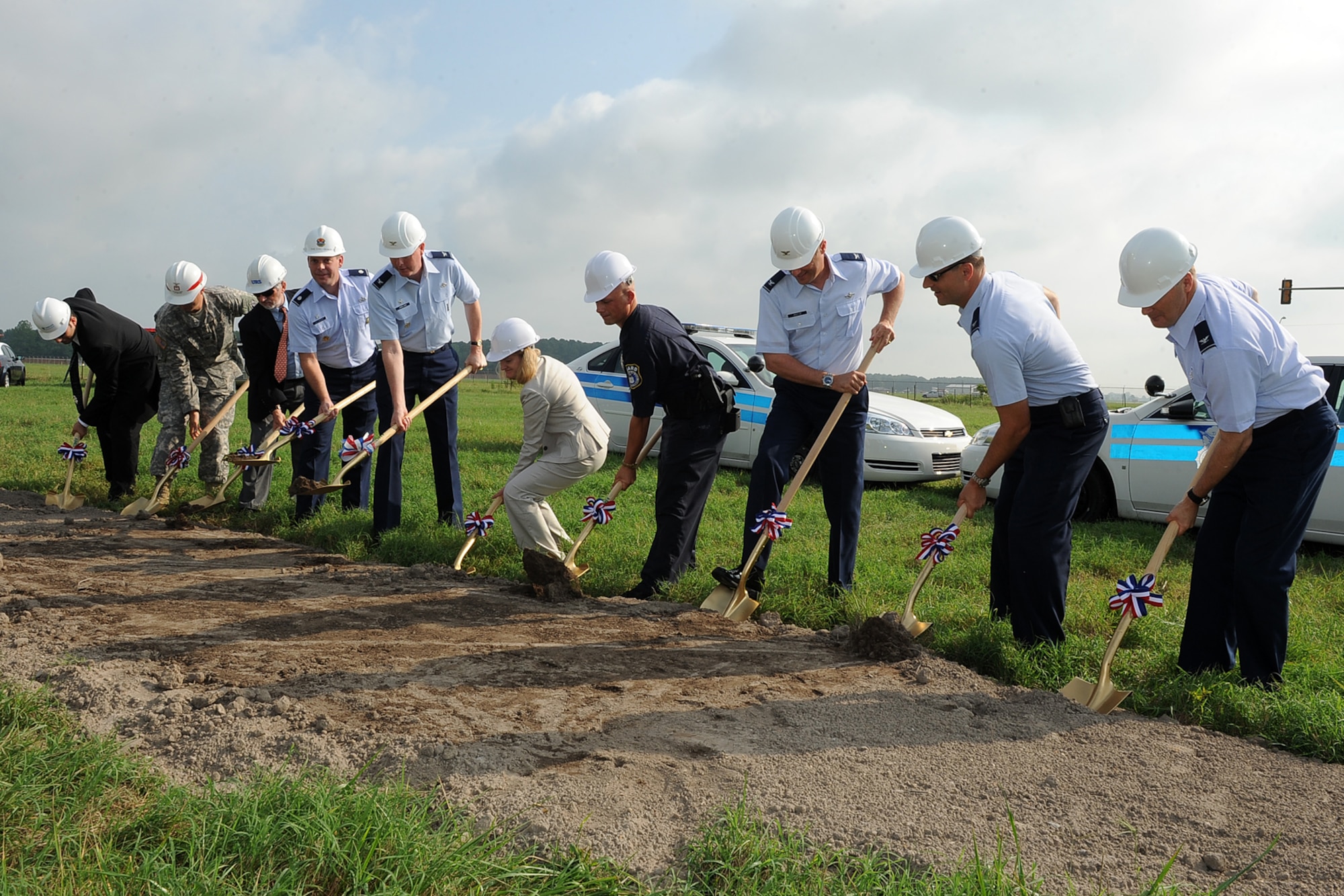 LANGLEY AIR FORCE BASE, Va. - Col. Donald Kirkland, 633d Air Base Wing commander, Lt. Col. Jeffrey Ullmann, 633d Civil Engineer Squadron commander, City of Hampton Mayor Molly Ward, and others perform a ground breaking ceremony Aug. 9. The ceremony was held for a $ 7.2 million state of the art, large vehicle inspection station near the Armistead Gate. (U.S. Air Force photo/Senior Airman Gul Crockett)