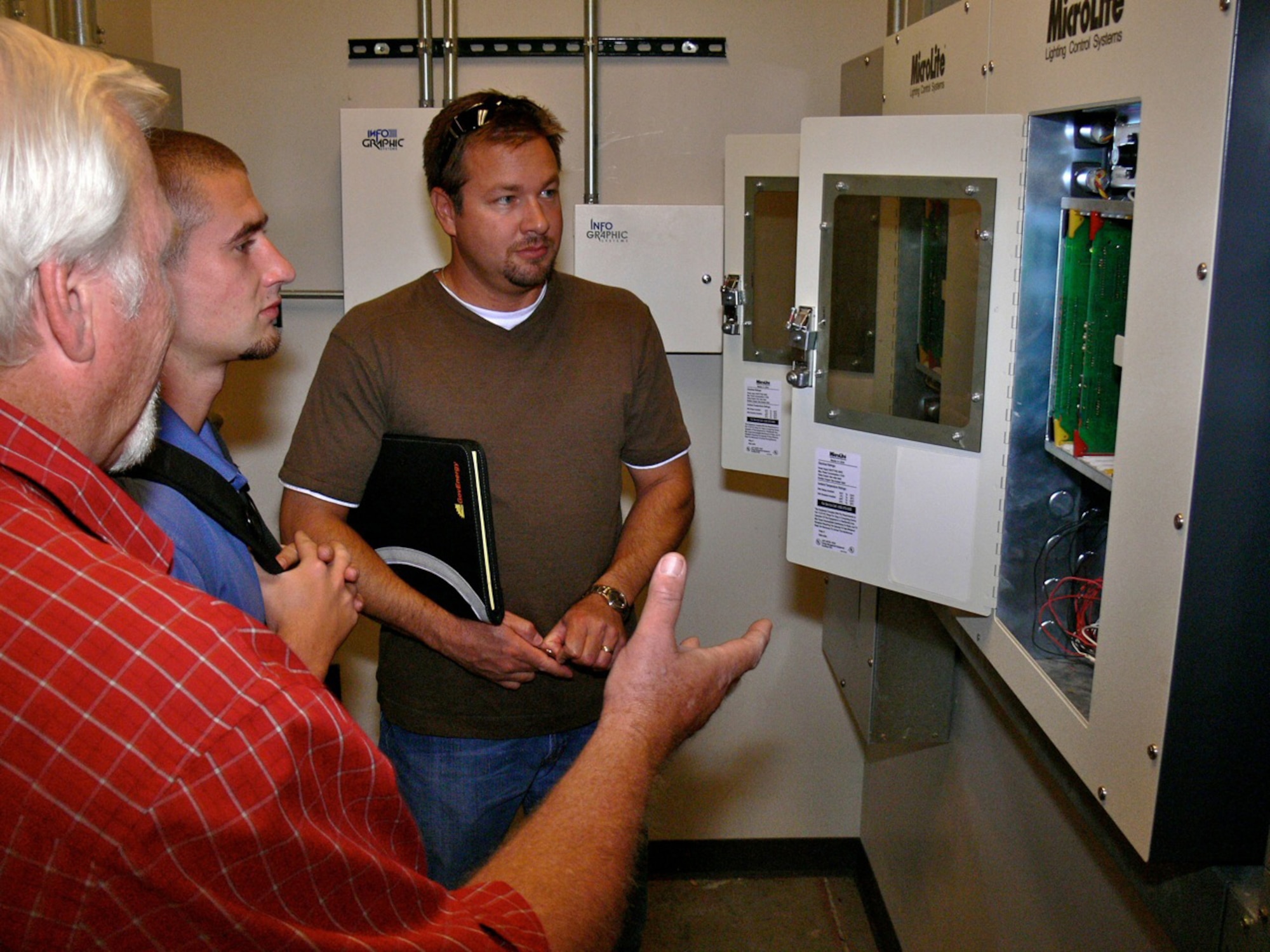 Randy Pieper, (far left) 21st Civil Engineer Squadron resource efficiency manager, shows members of an audit team, electrical boxes inside Building 350 July 22. The audit team looked at the energy efficiency of several buildings on Peterson Air Force Base and will make recommendations on how the base can improve its energy efficiency as part of an Air Force-wide energy savings plan. The Air Force has set aside $250 million each year for the next four years for energy efficiency projects. (U.S. Air Force photo/Monica Mendoza)