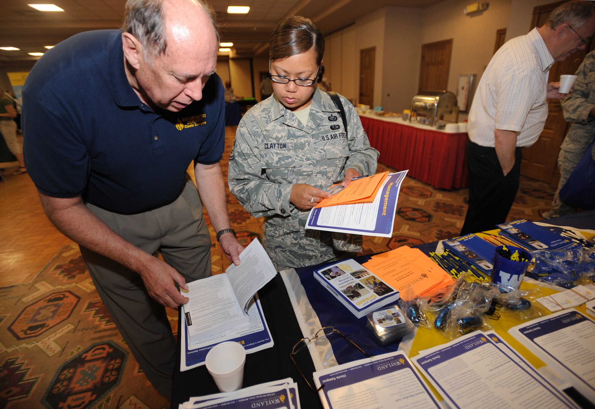 U.S. Air Force Tech. Sgt. Marilyn Clayton, 27th Special Operations Medical Operations Squadron, collects information from Education Fair Aug. 5, 2010. Numerous representatives from different schools visited Cannon Air Force Base to tout their institutions of higher learning to base personnel. (U.S. Air Force photo by Airman 1st Class Maynelinne De La Cruz)