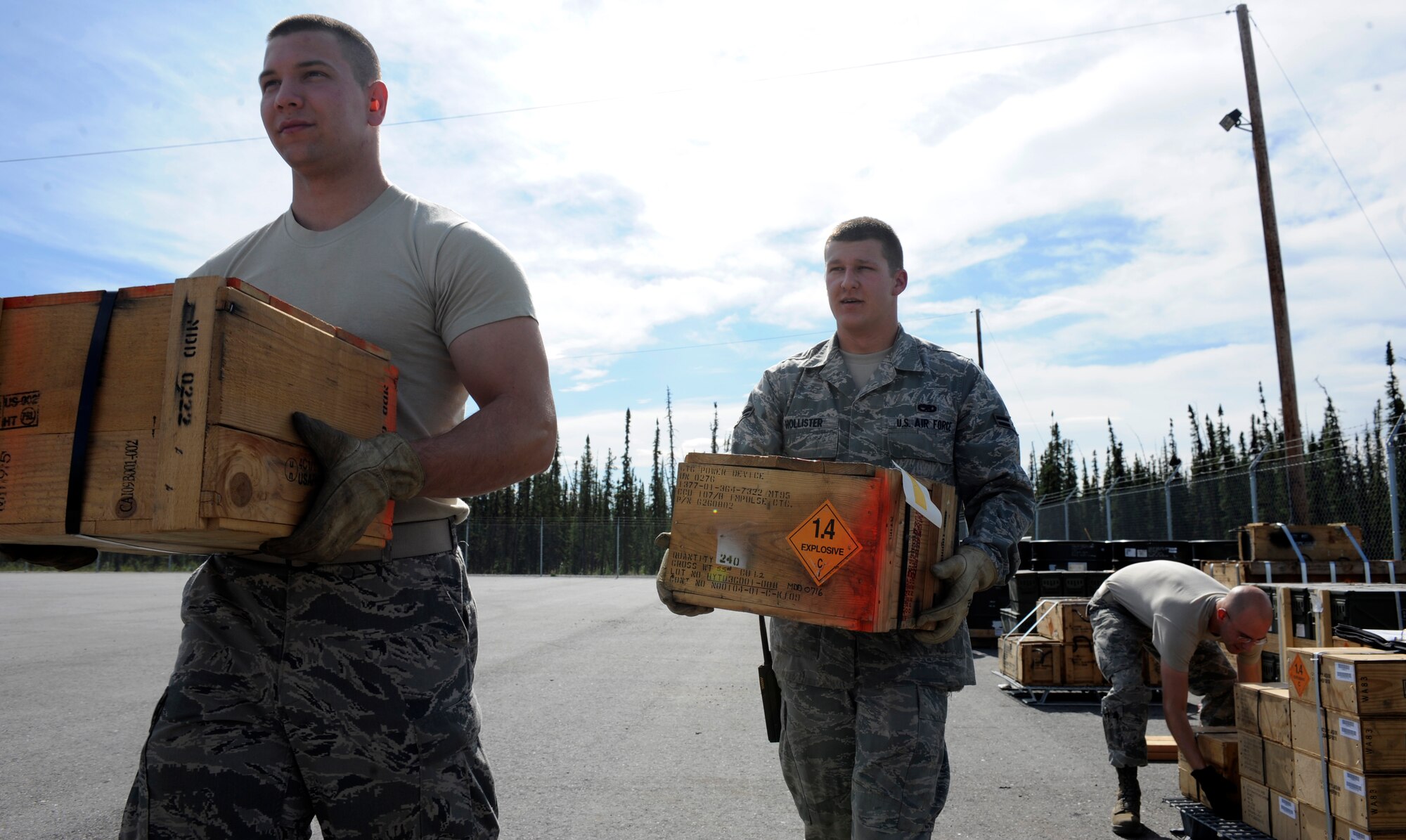 Airmen 1st Class Matthew Beall, Nathaniel Hollister, and Christopher Lynch carry impulse cartridges August 6, 2010, Eielson Air Force Base, Alaska. The Airmen are palletizing impulse cartridges in preparation for an outbound munitions shipment. The Airmen are munitions storage crewmembers assigned to the 354th Munitions Flight. (U.S. Air Force photo/Senior Airman Willard E. Grande II)