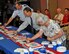 Col. Stefan Dosedel (from left), Ross Marshall and Lynn Moad, all members of the Expeditionary Combat Support System leadership team, celebrate the Hanscom Air Force Base, Mass., Release One-Pilot A of the system at a gathering hosted at Wright-Patterson AFB, Ohio, Aug. 2. (Courtesy photo)
