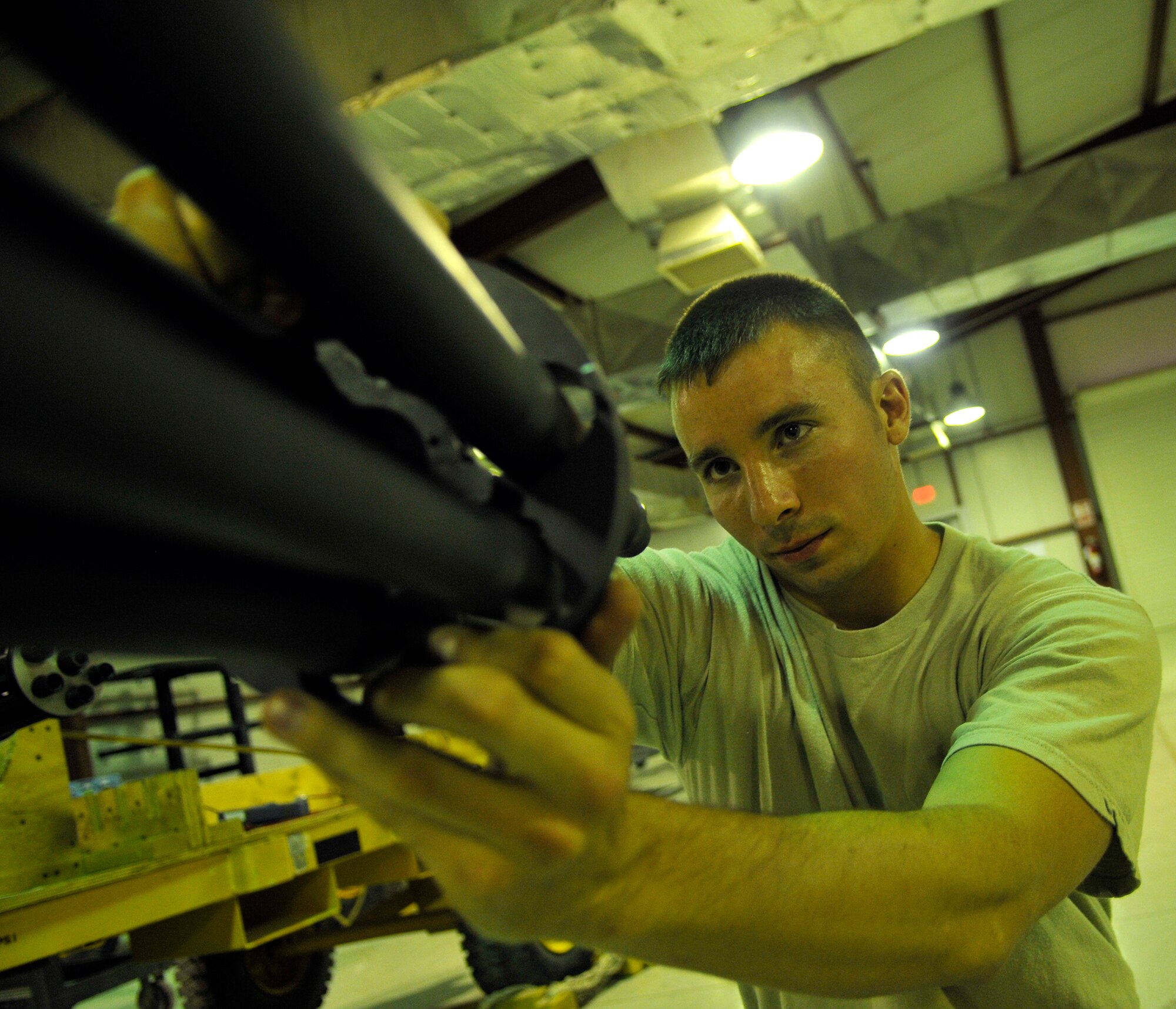 Senior Airman Matthew Wilson, 332nd Expeditionary Maintenance Squadron Armament Flight specialist, slides a M61A1 Gatling-type gun center clamp over the muzzle during a weapons build Aug. 6, 2010, Joint Base Balad, Iraq. The center clamp aids in keeping the barrels from twisting as the weapon spins. Airman Wilson, a native of Lexington, S.C., is deployed from Shaw Air Force Base, S.C. (U.S. Air Force photo/Staff Sgt. Phillip Butterfield)